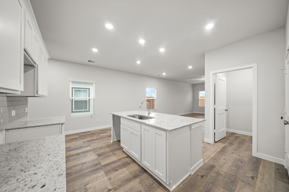 A kitchen with white cabinets.