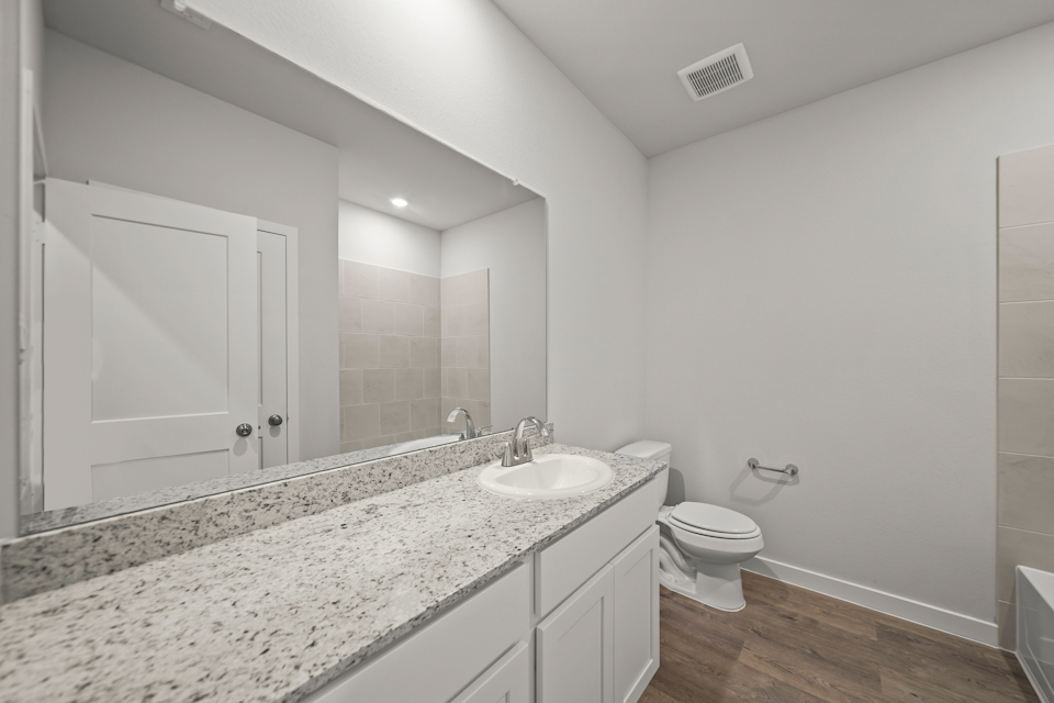 A bathroom with a marble countertop.