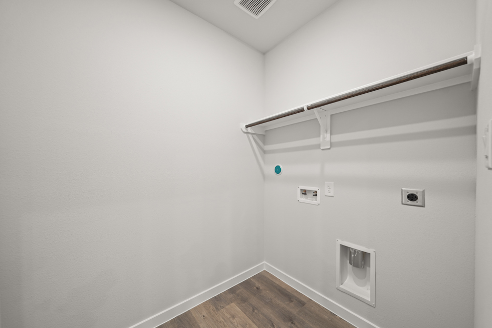 A white room with a wood floor and a wood floor.