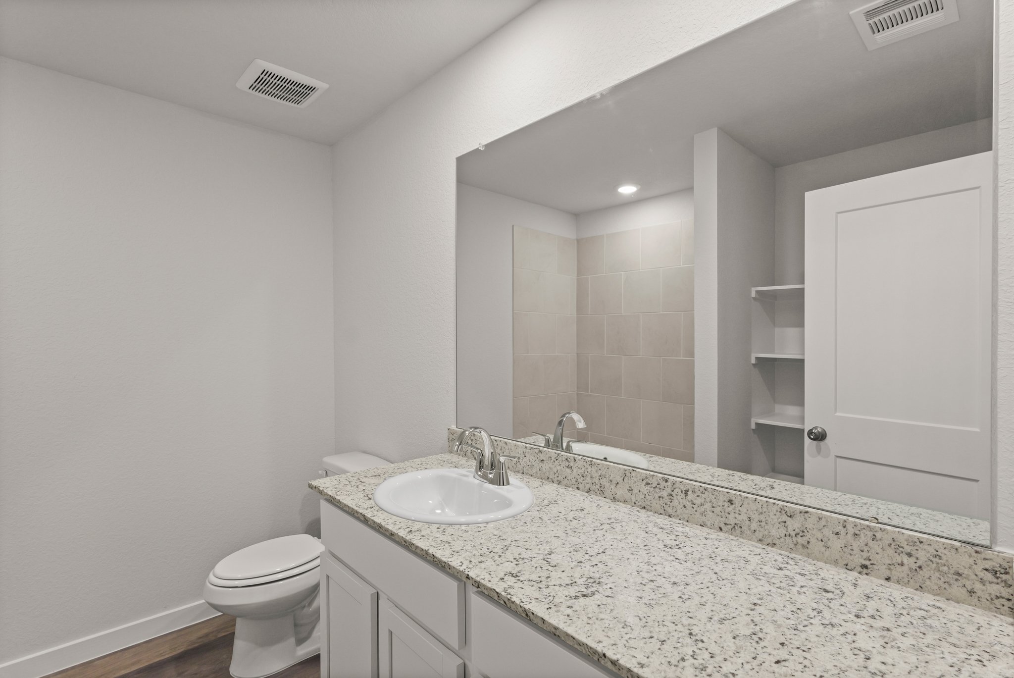 A bathroom with a marble countertop.