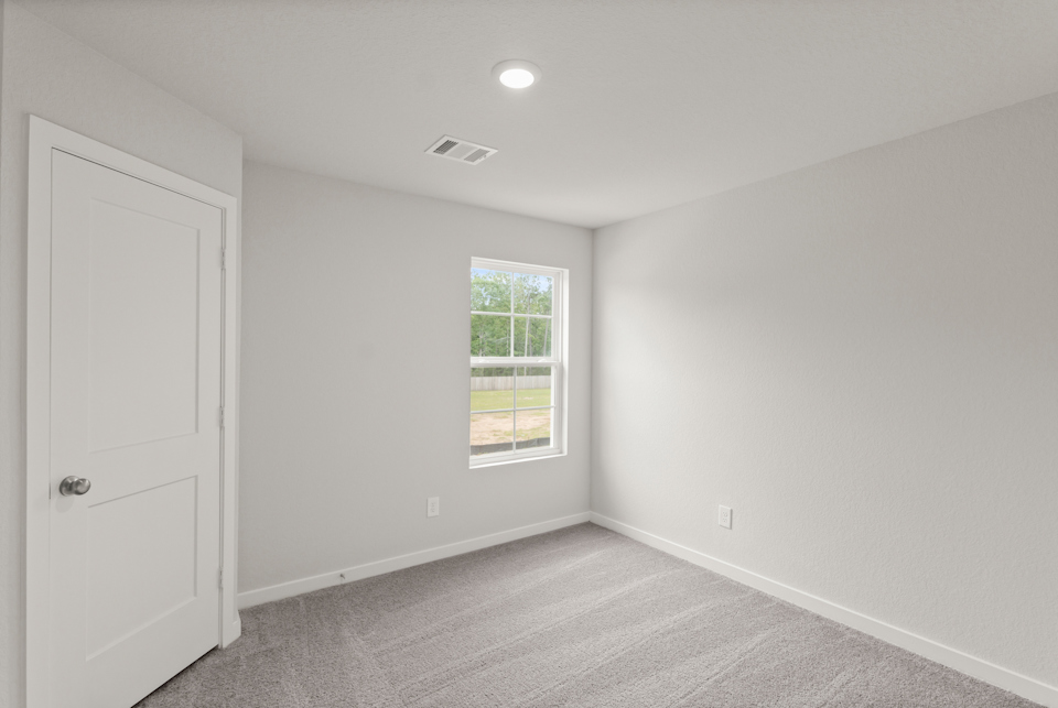 A room with a window and a door.