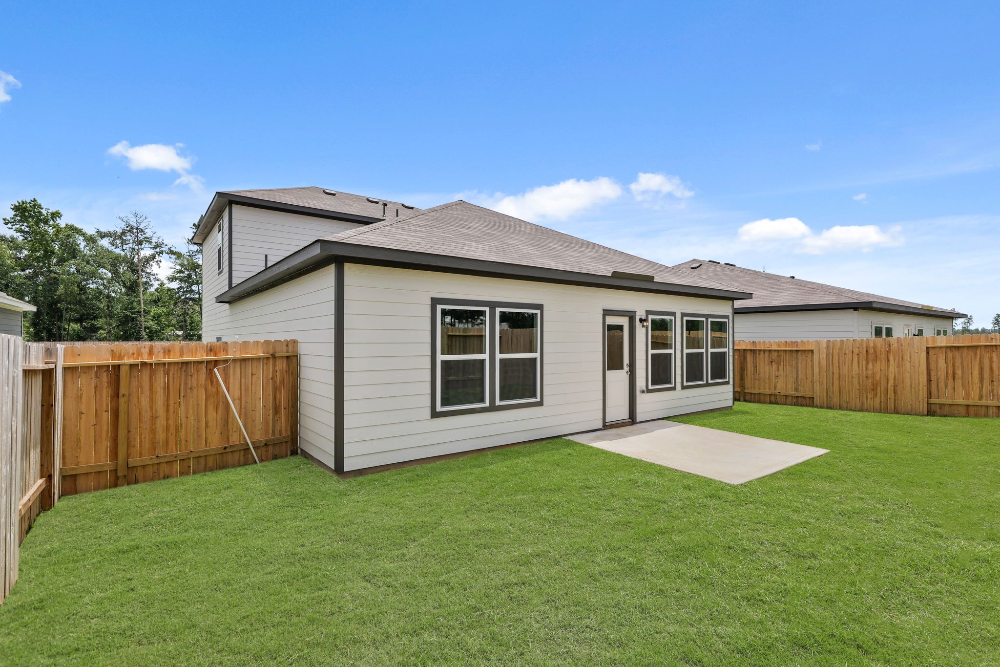 A house with a fence and a yard.