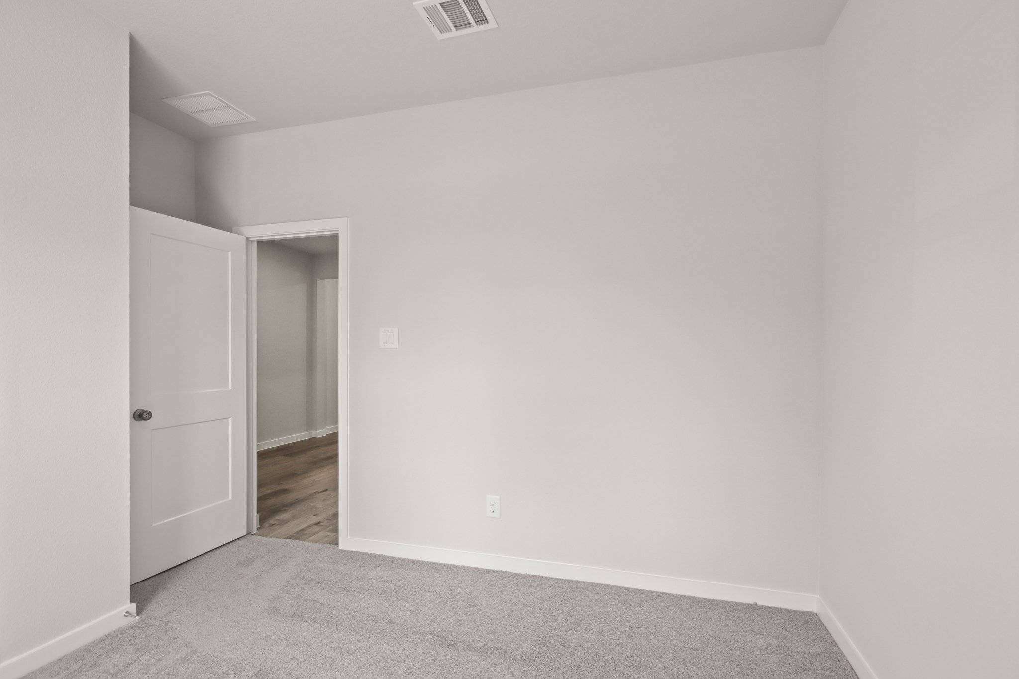 A hallway with white walls.