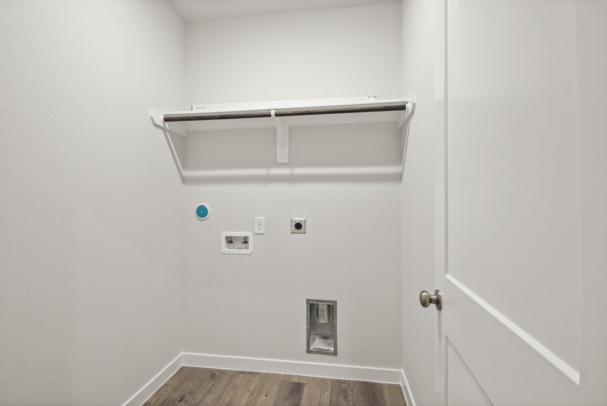 A white wall with a light fixture.