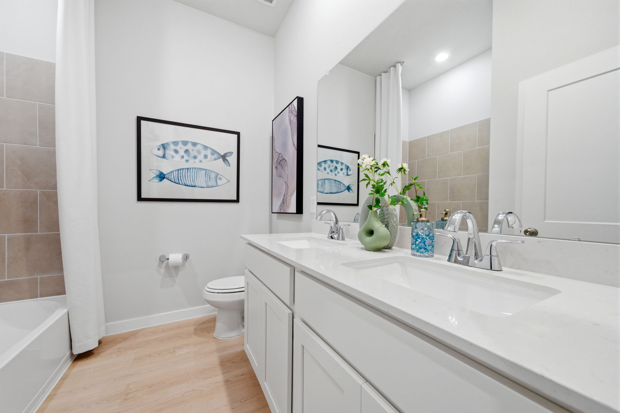 A bathroom with a tub sink and toilet.