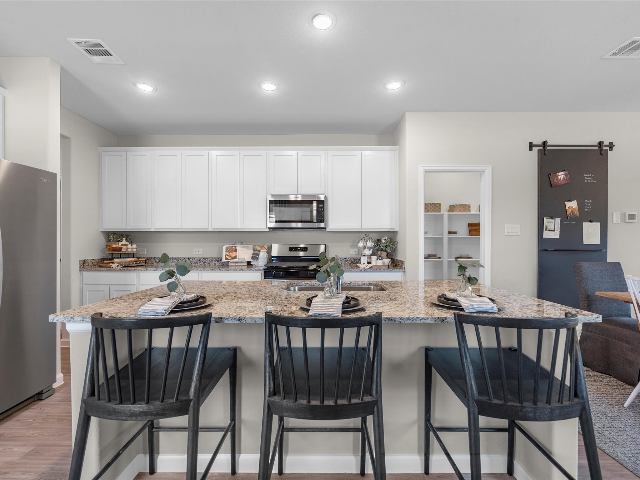 A kitchen with white cabinets.