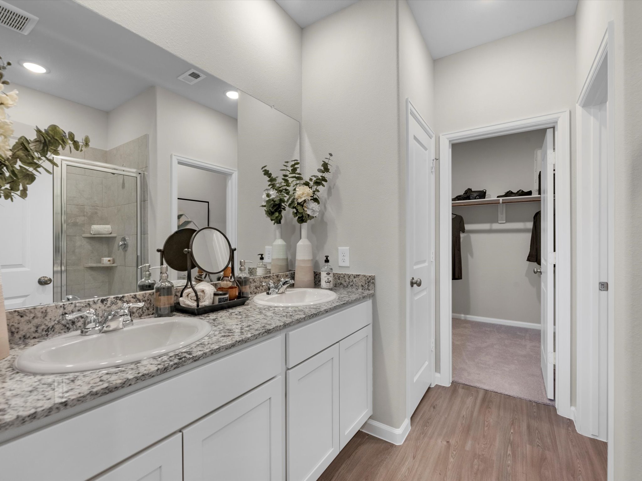 A bathroom with a large mirror.