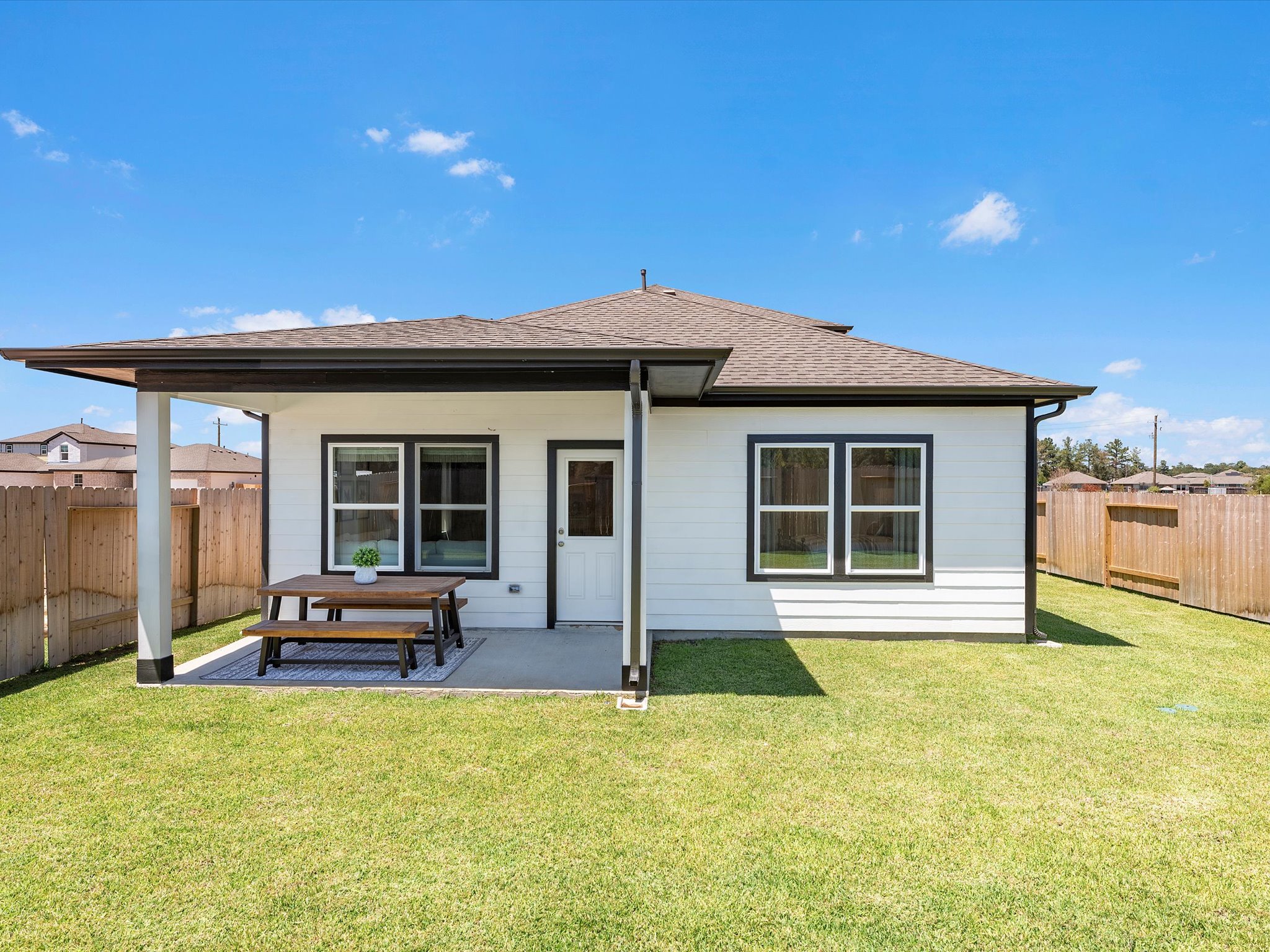 A small house with a picnic table.