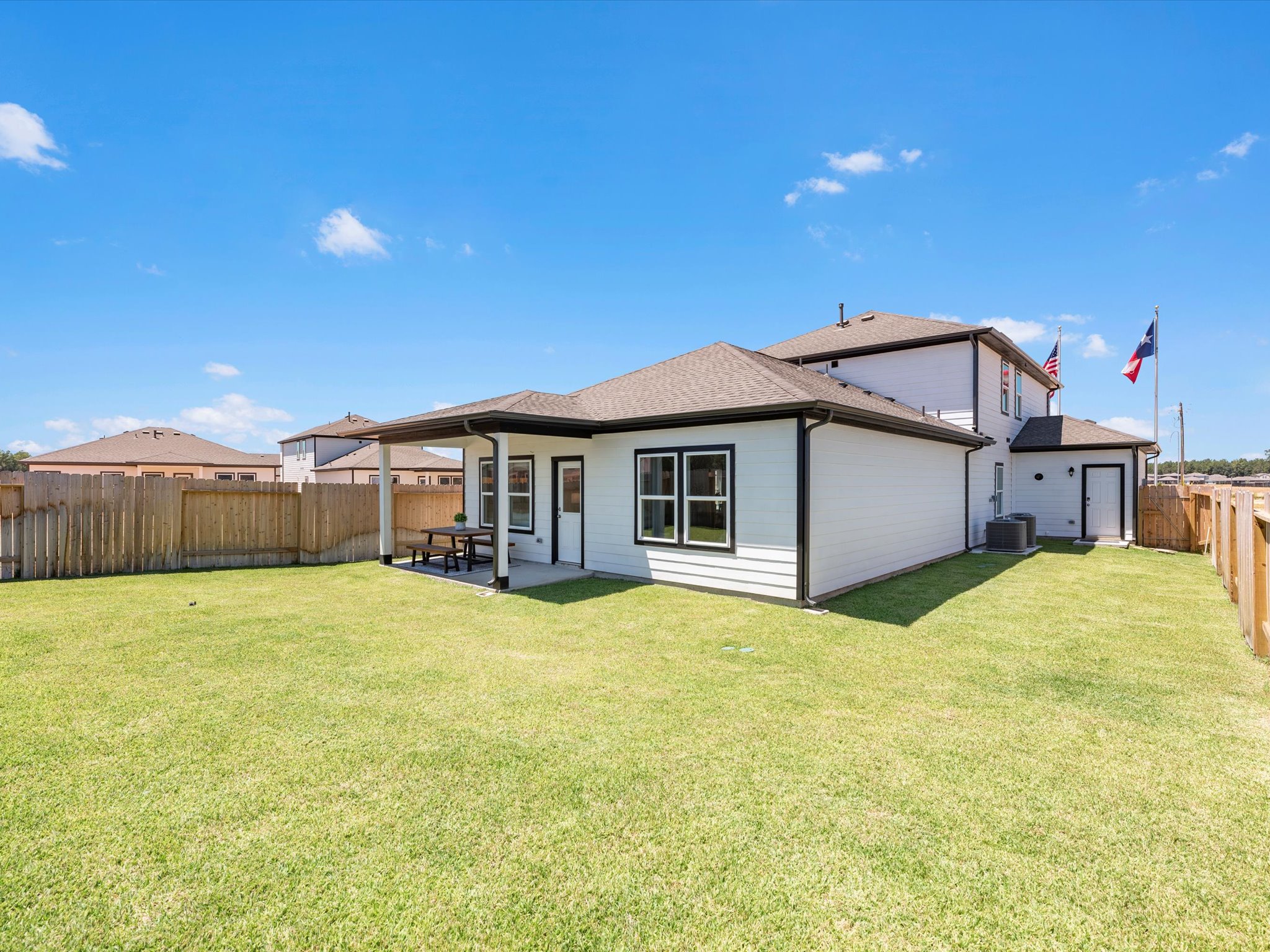A house with a fence and grass.