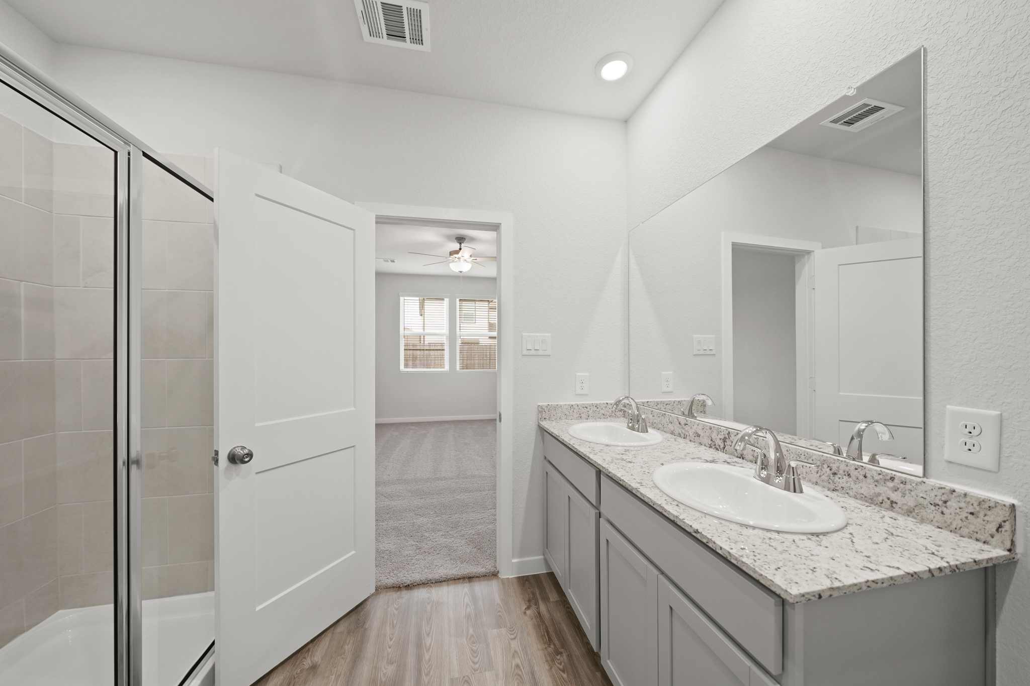 A bathroom with a large mirror.