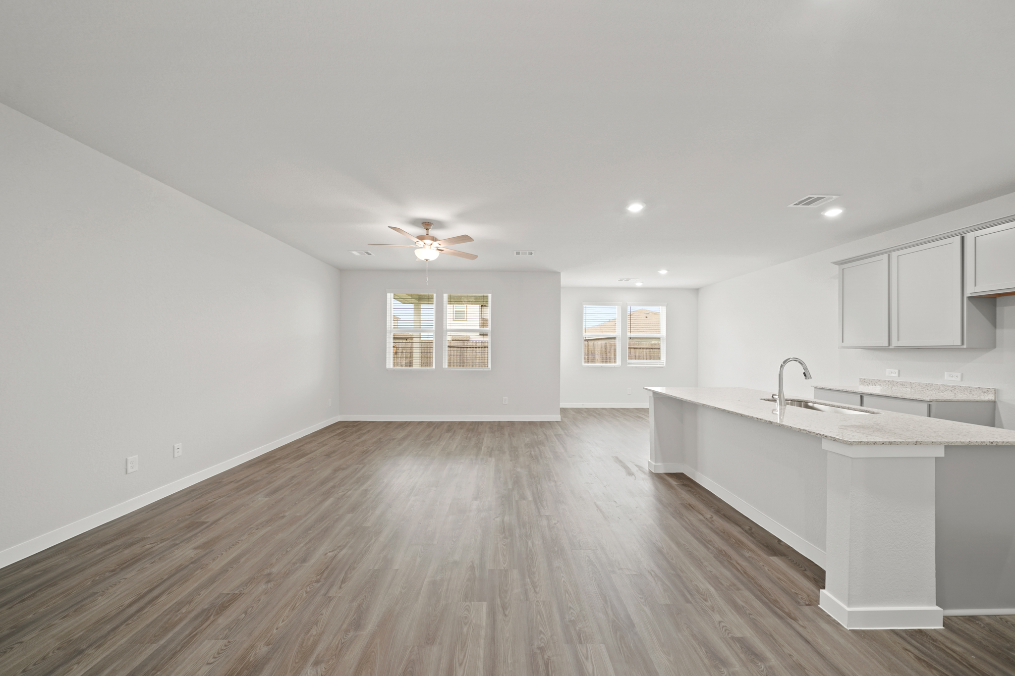 A kitchen with a wood floor.