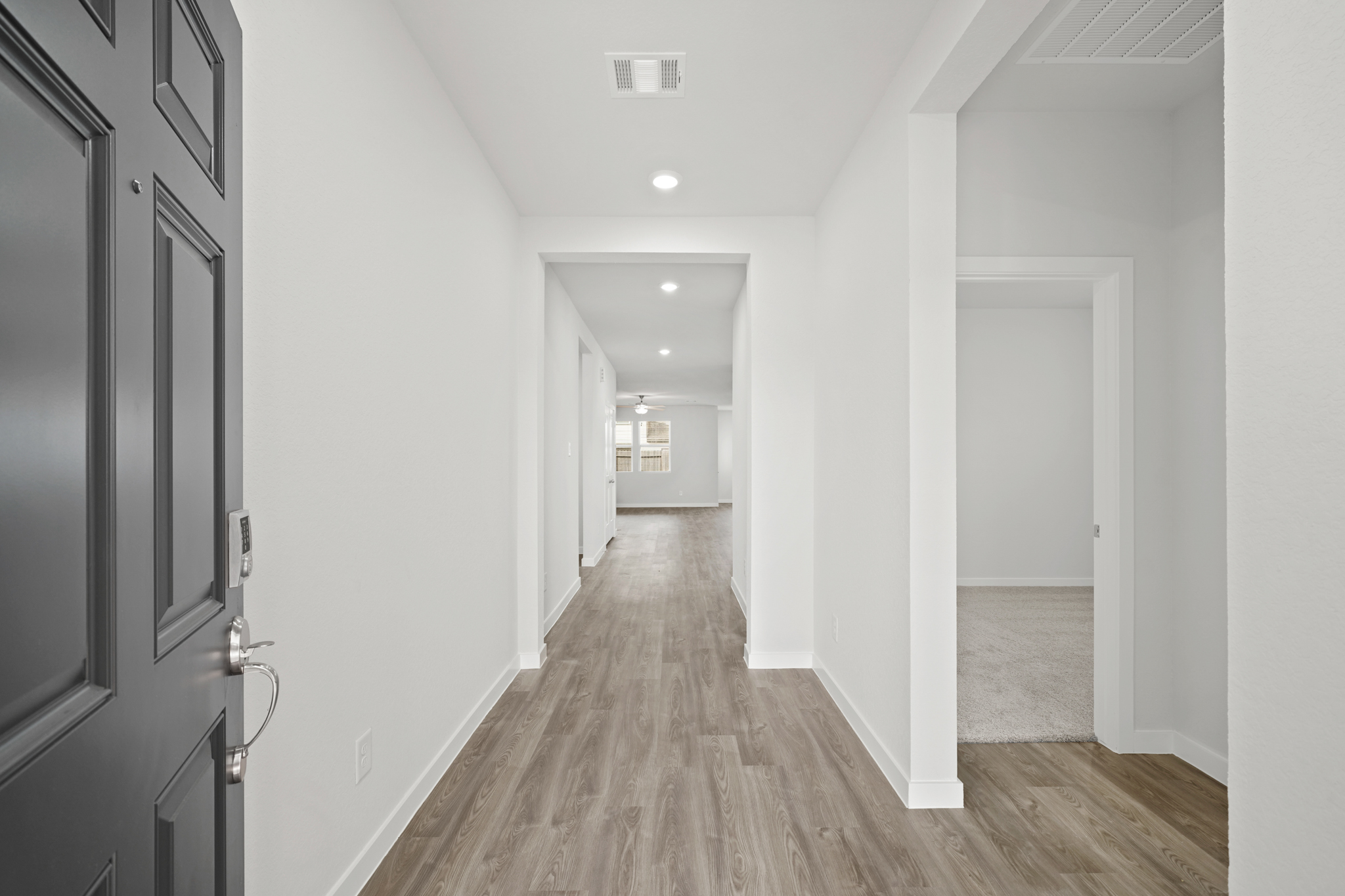A hallway with white walls.