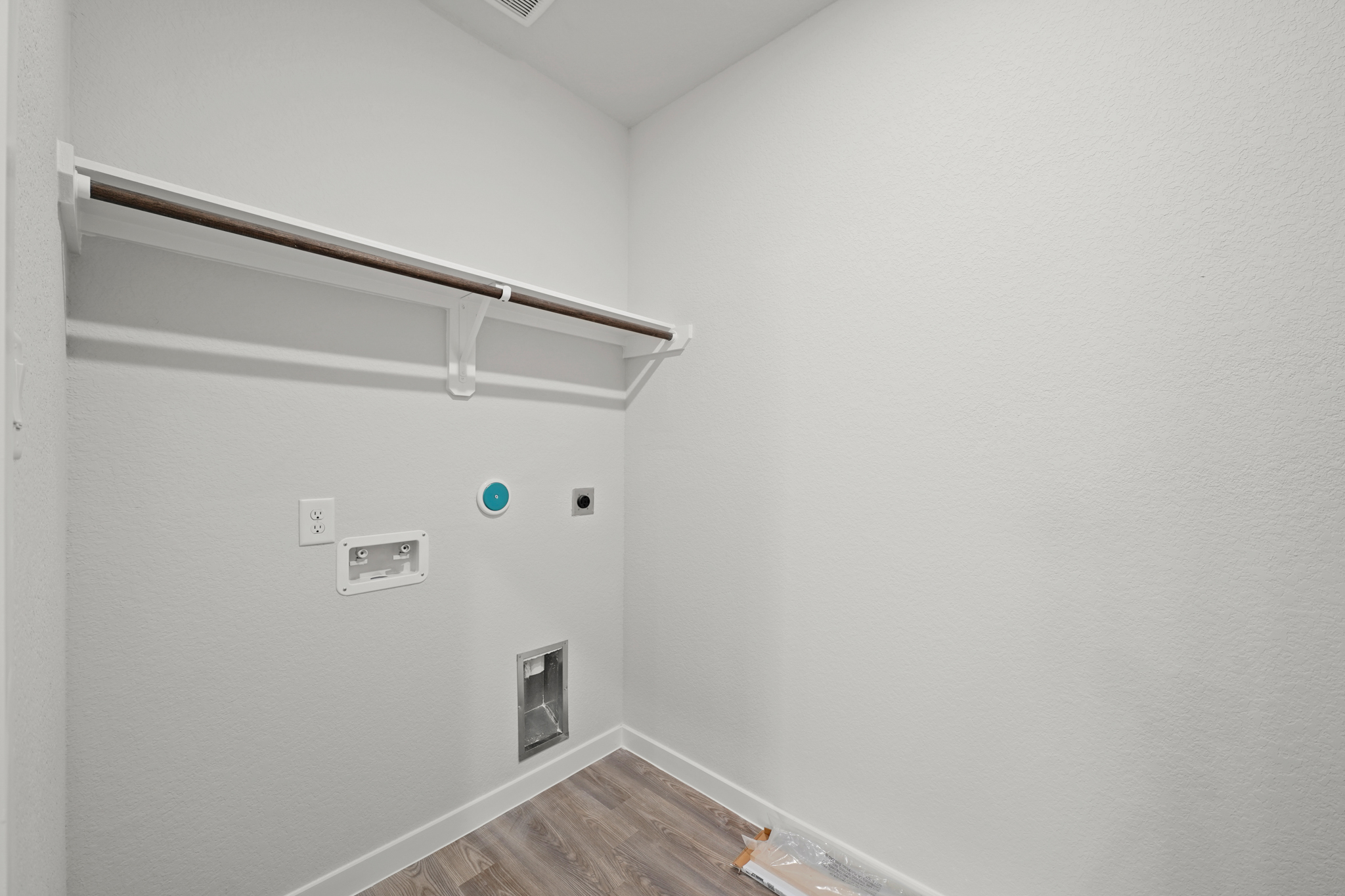 A white wall with a light fixture.