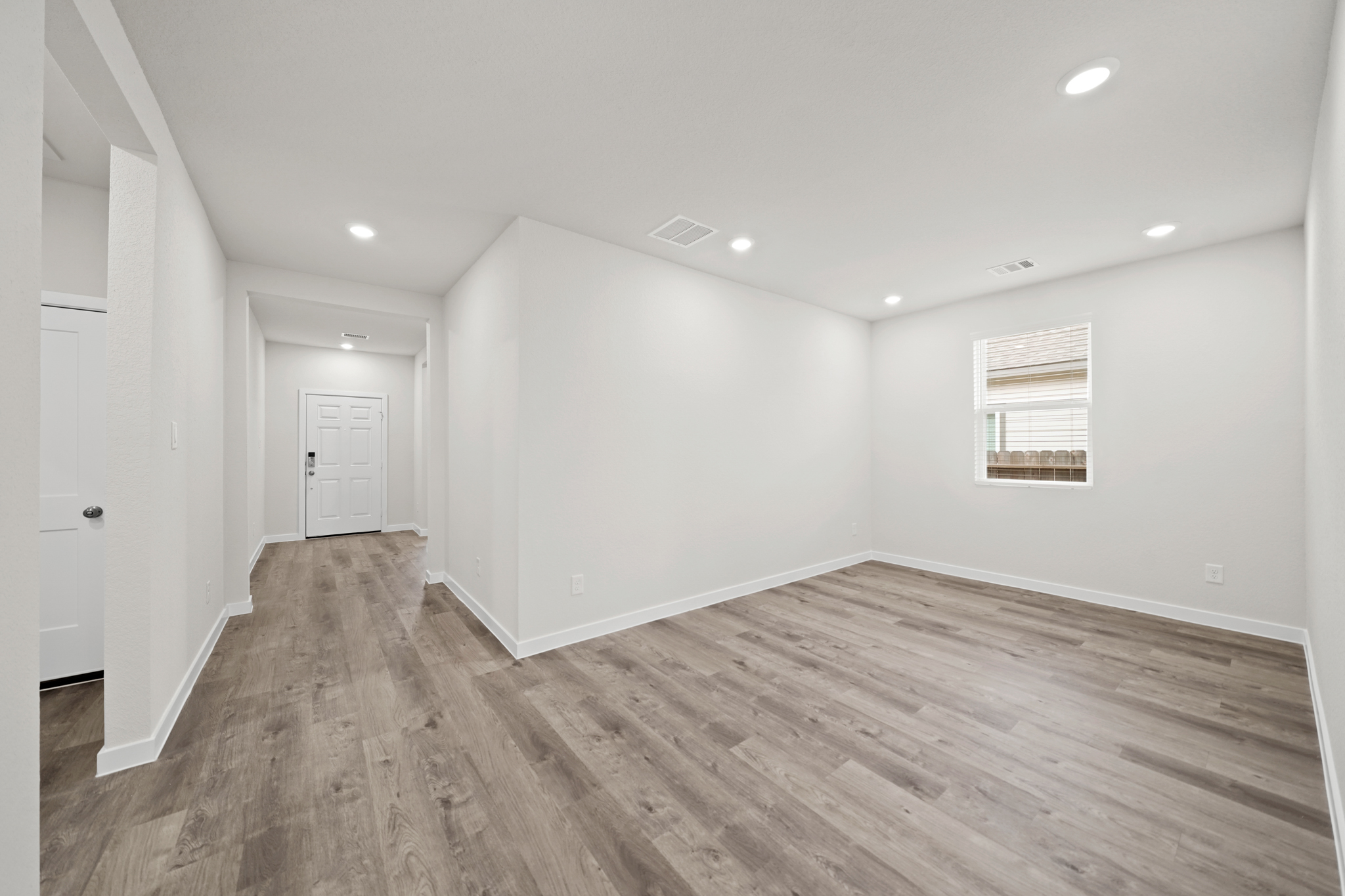 A room with a wood floor and white walls.