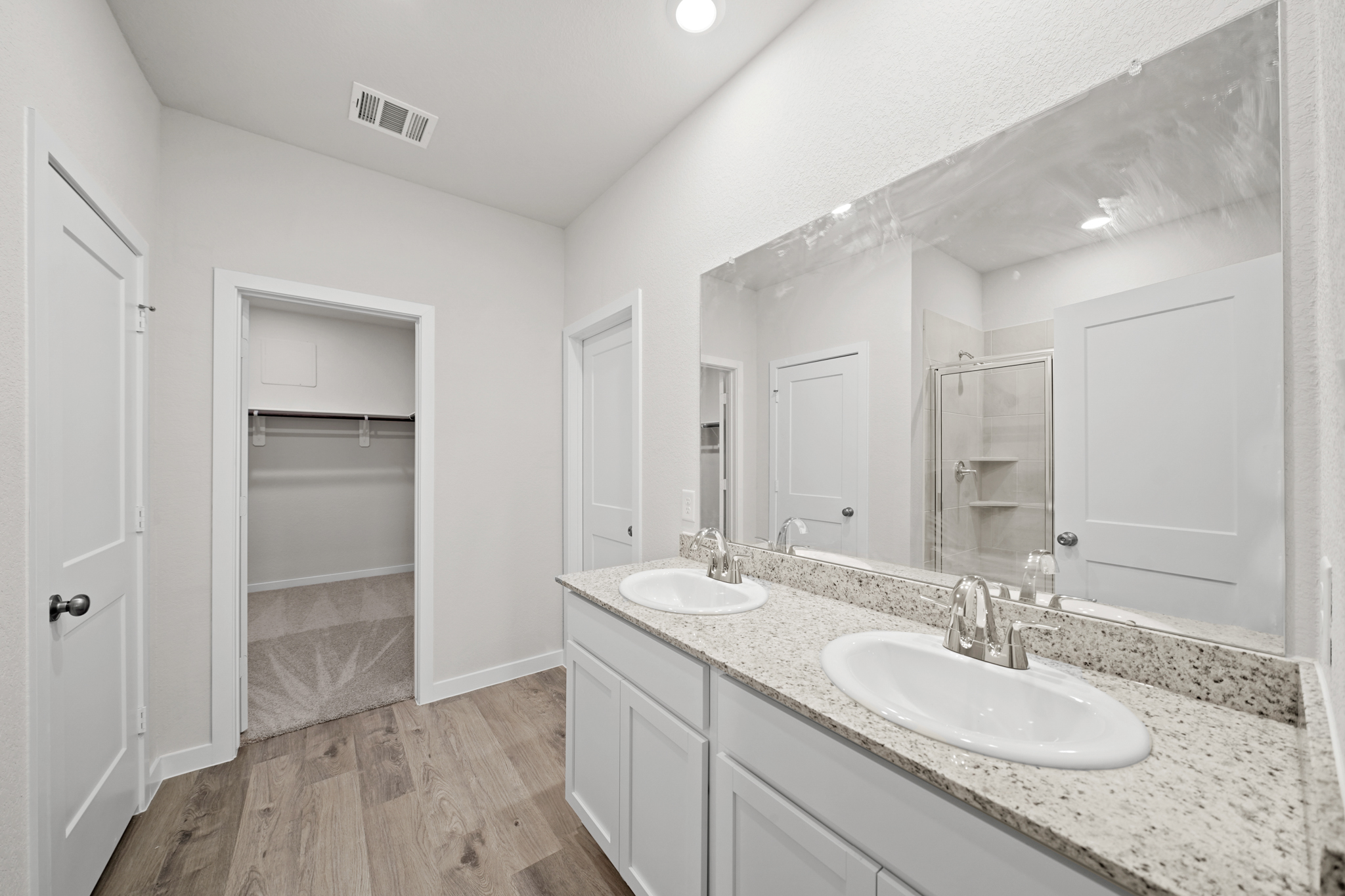 A bathroom with a large mirror.