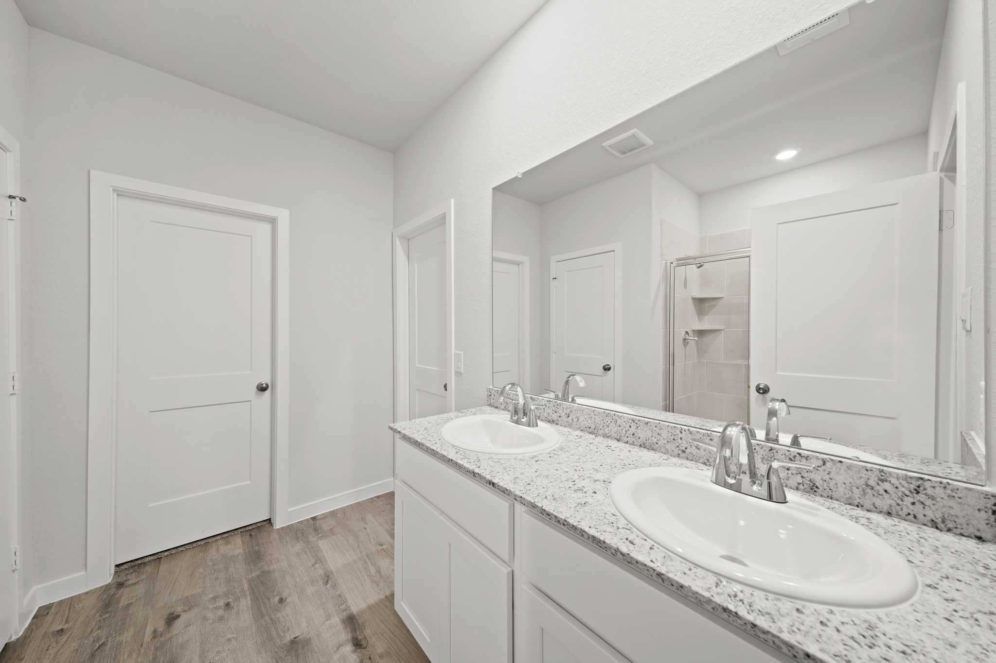 A bathroom with a large mirror.