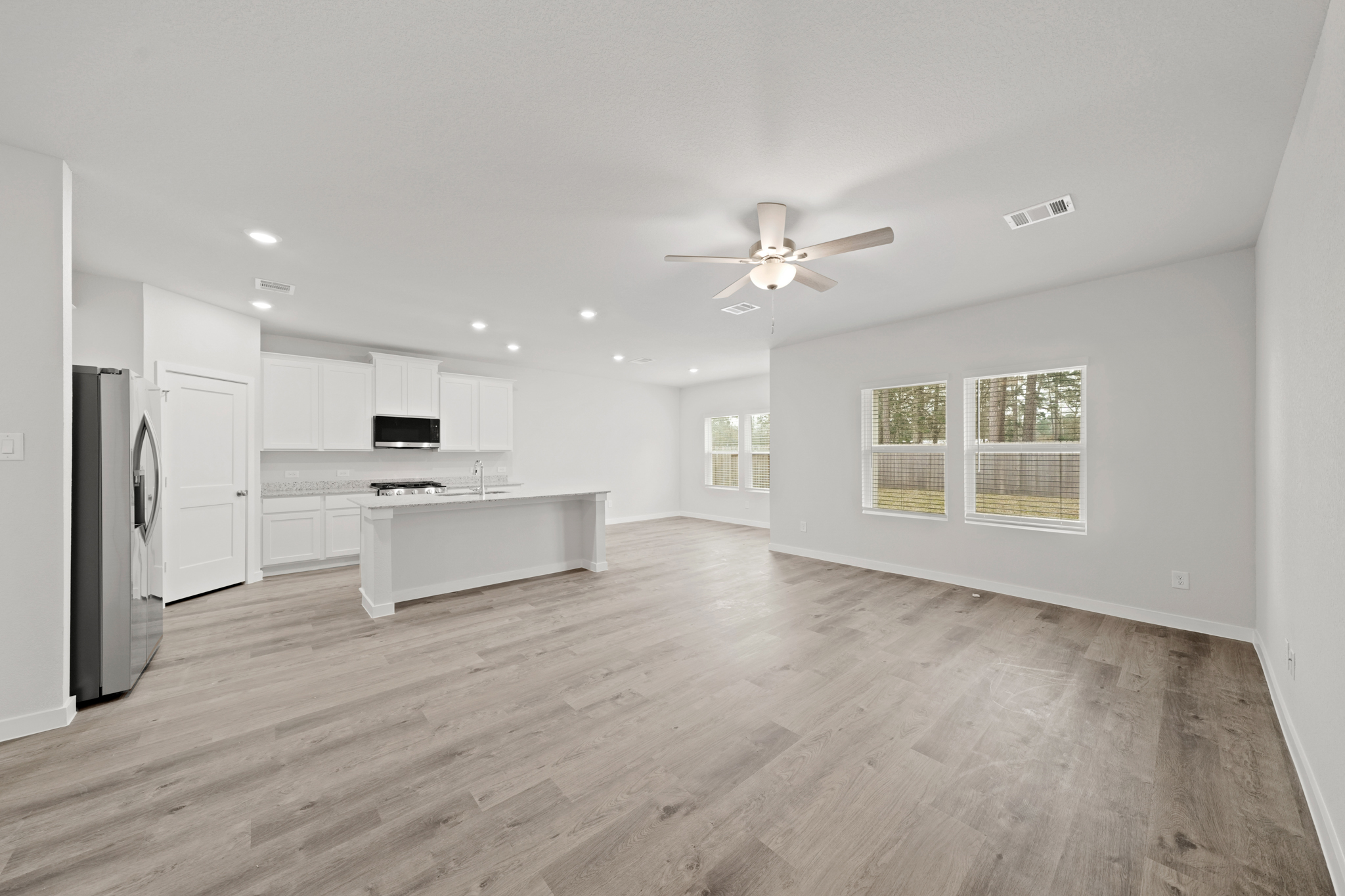 A large kitchen with white cabinets.