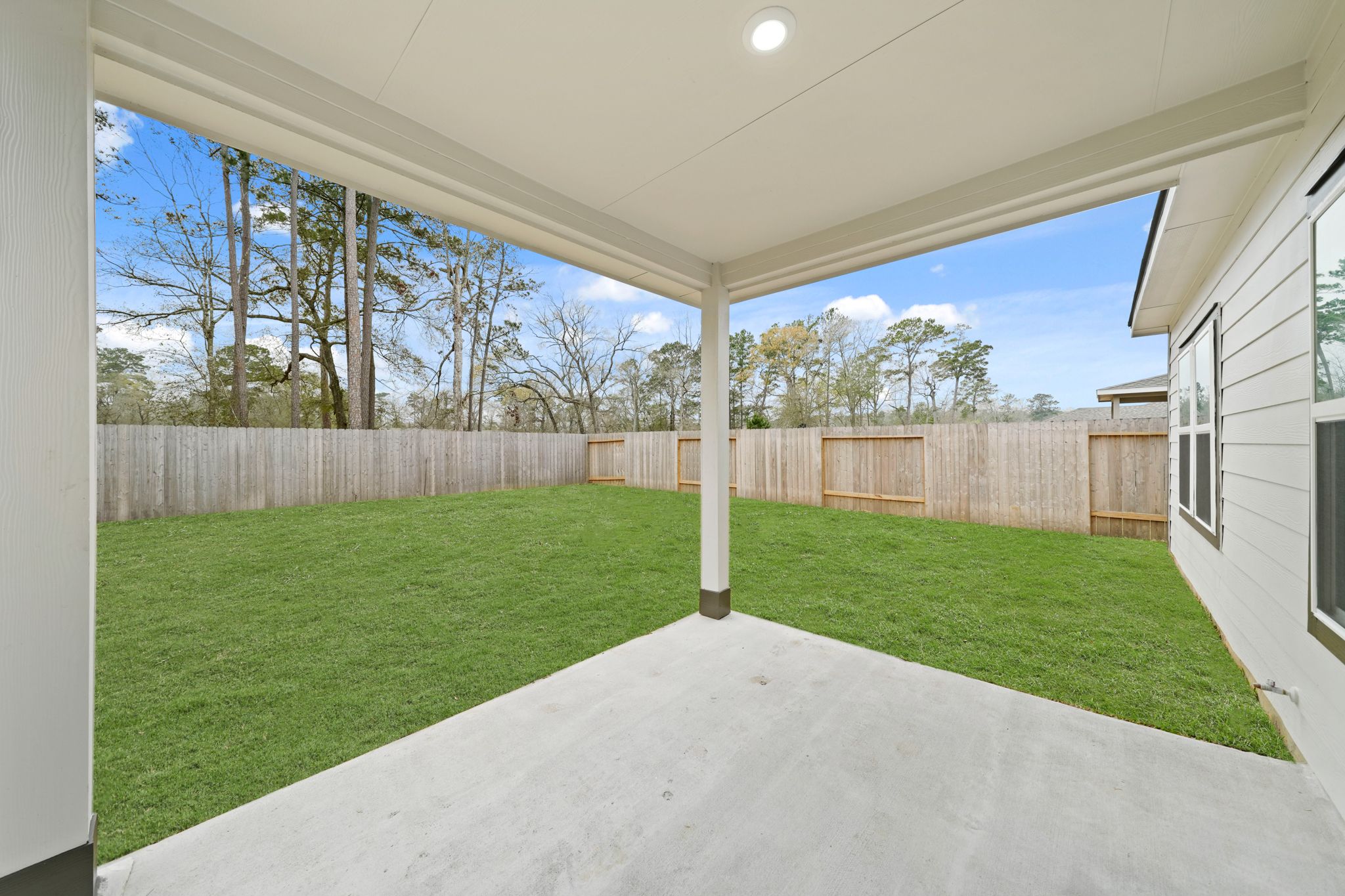 A backyard with a fence and a wood fence.