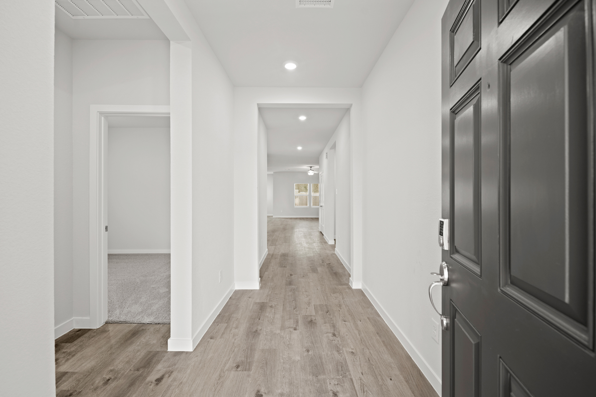 A hallway with black doors.