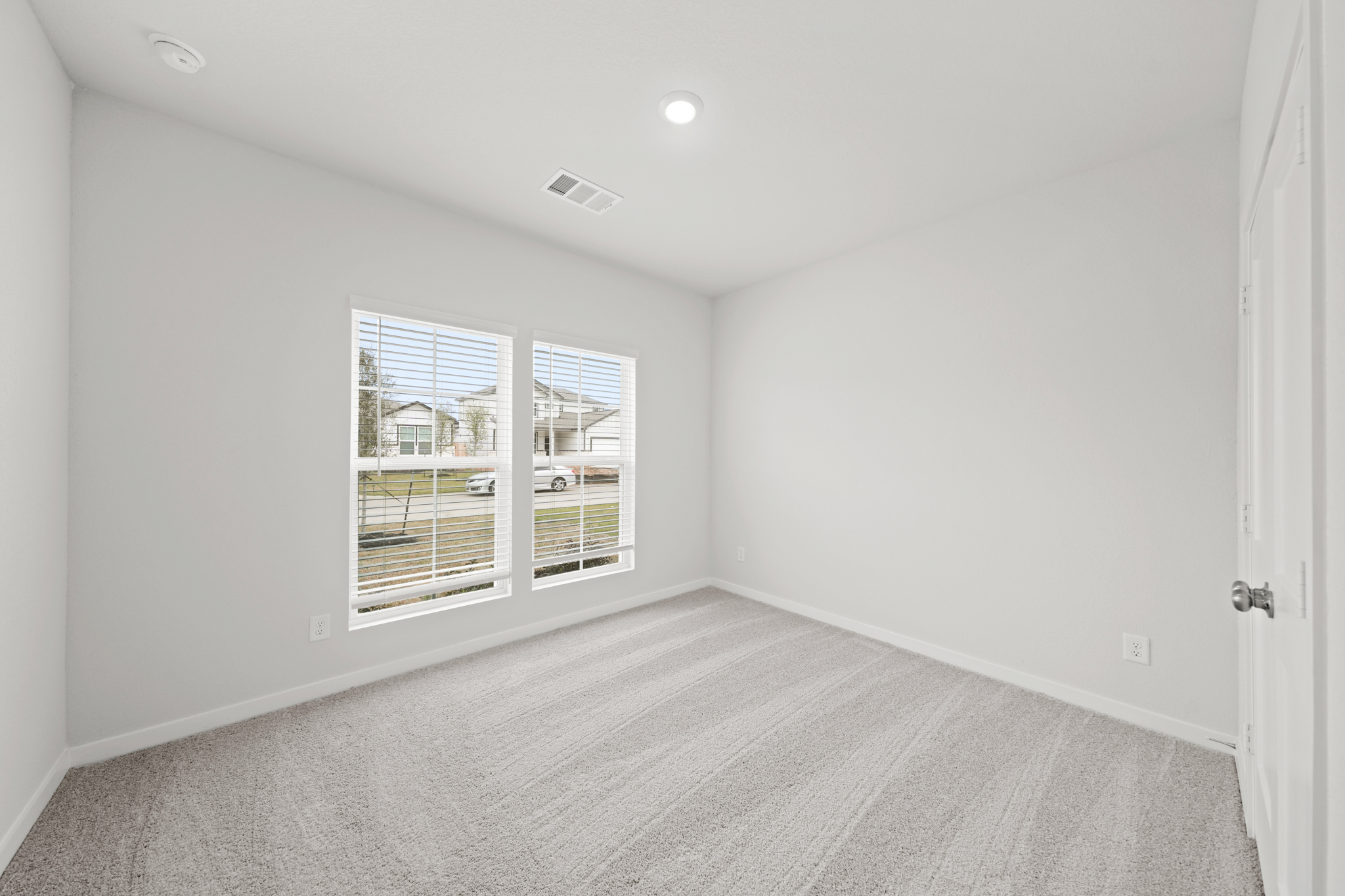 A room with a window and a carpet.