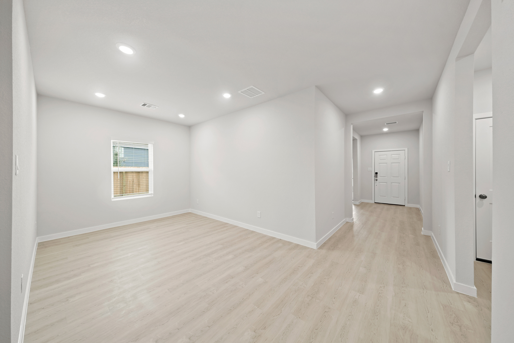 A room with a wood floor and white walls.