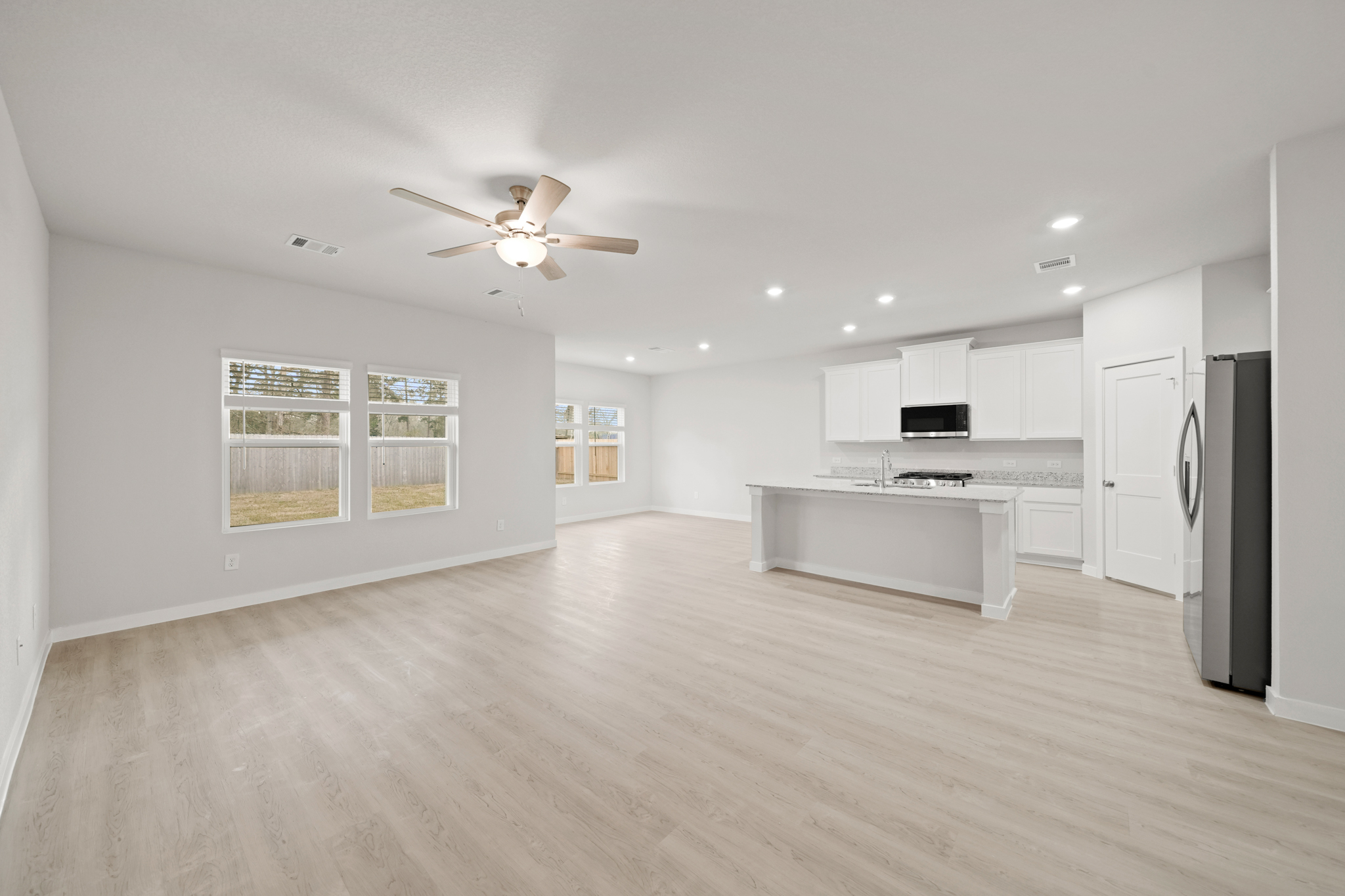 A large kitchen with white cabinets.