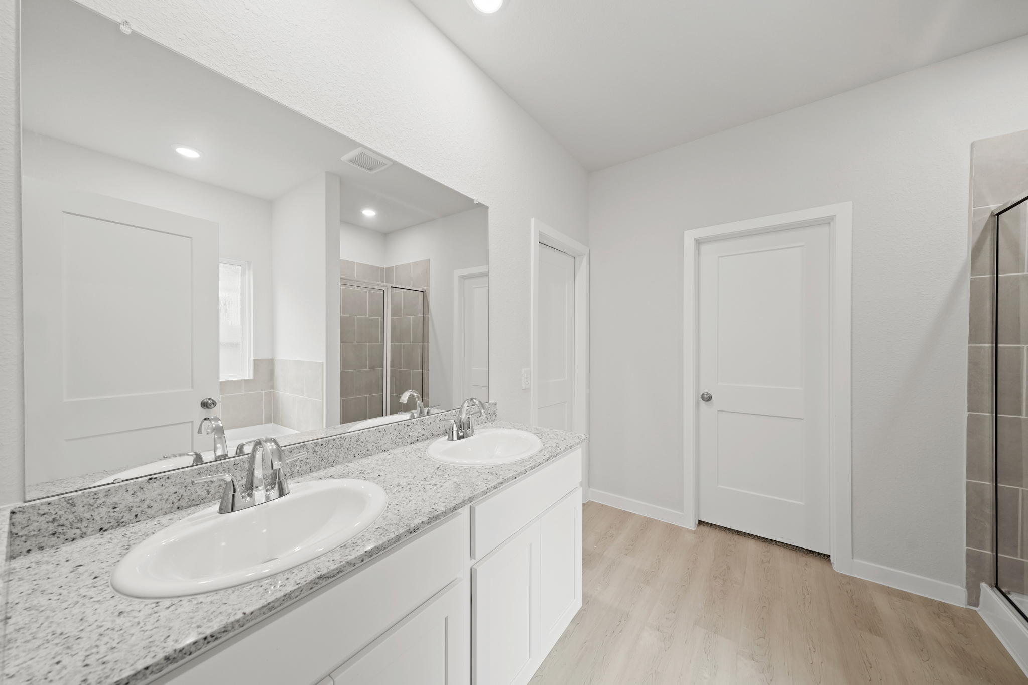 A bathroom with a large mirror.