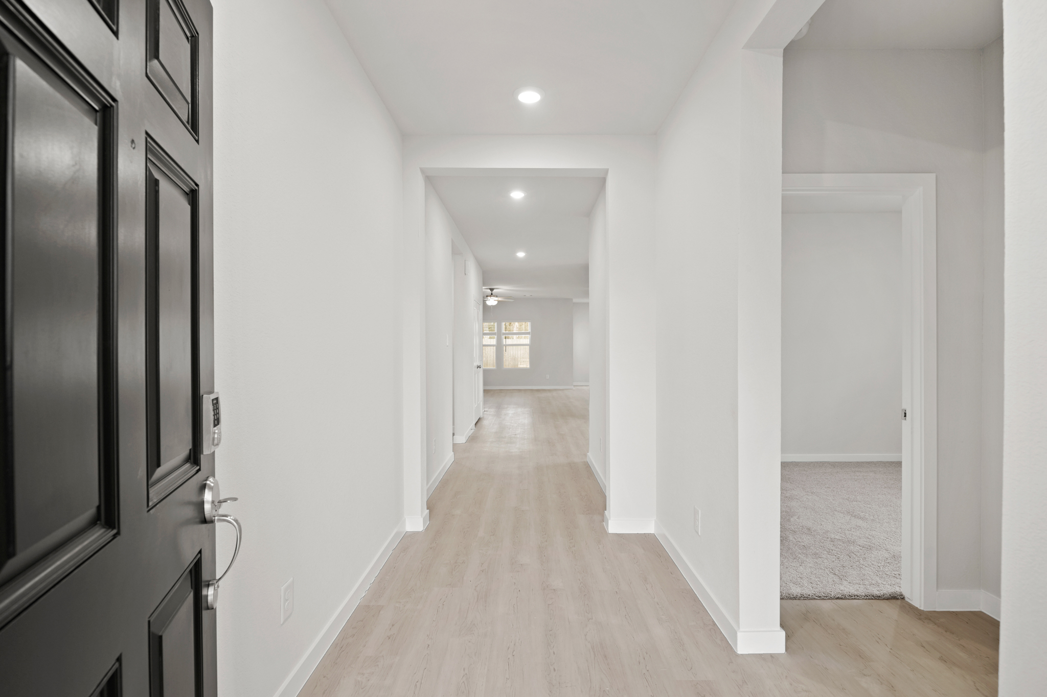 A hallway with white walls.