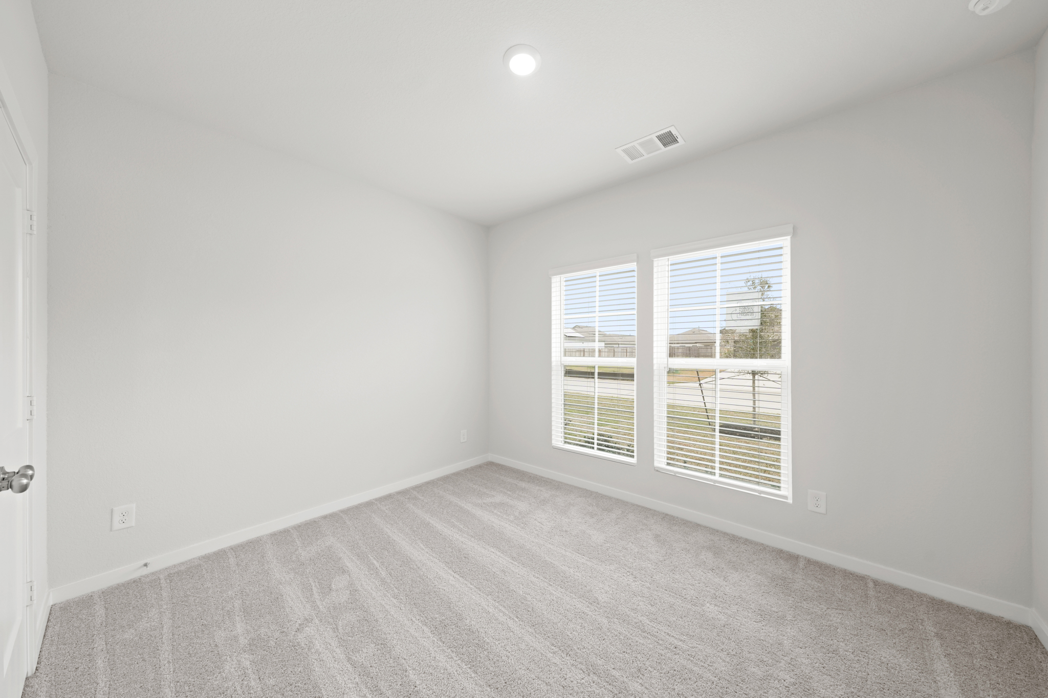 A room with a window and a door.