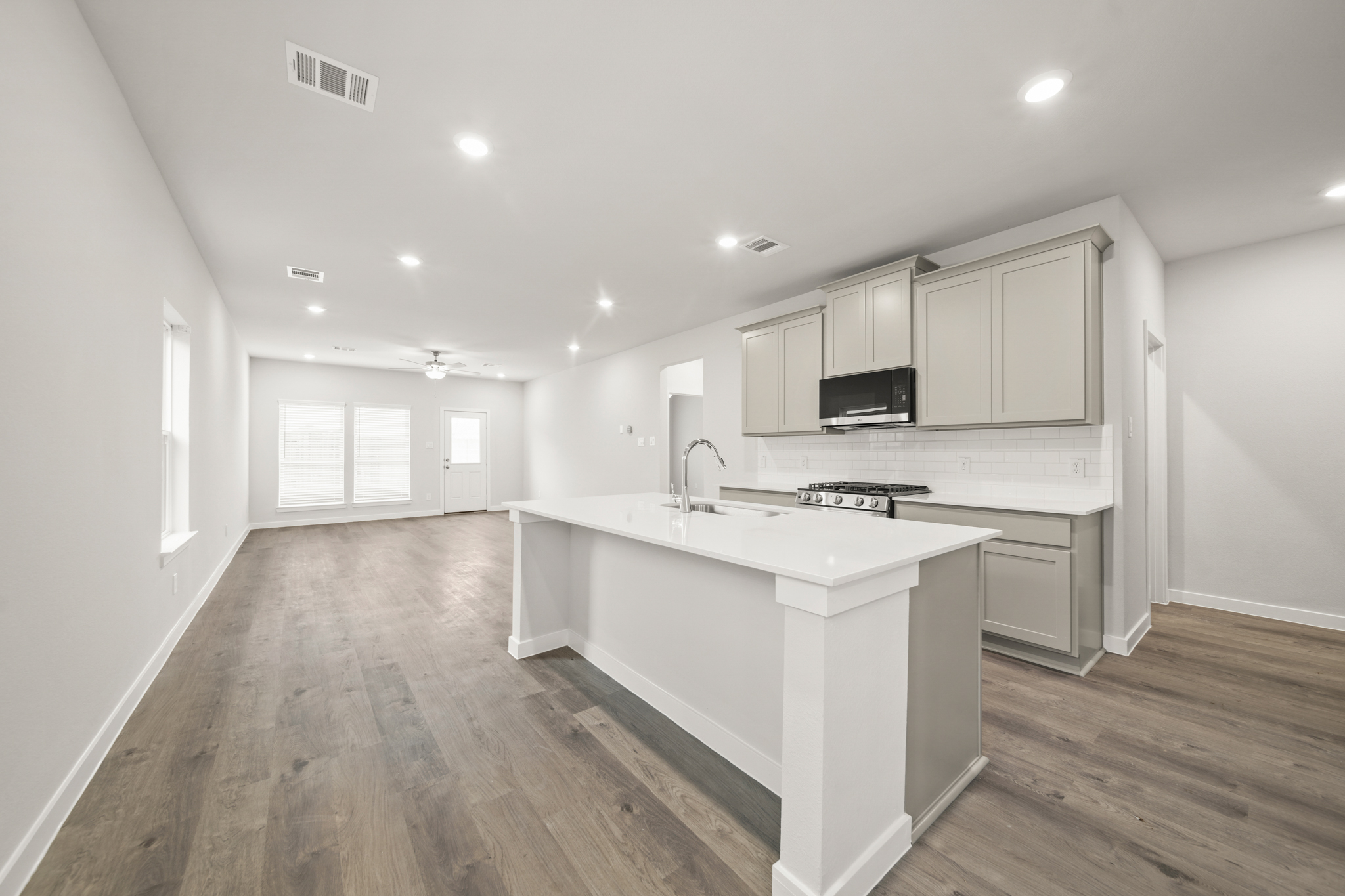 A kitchen with white cabinets.
