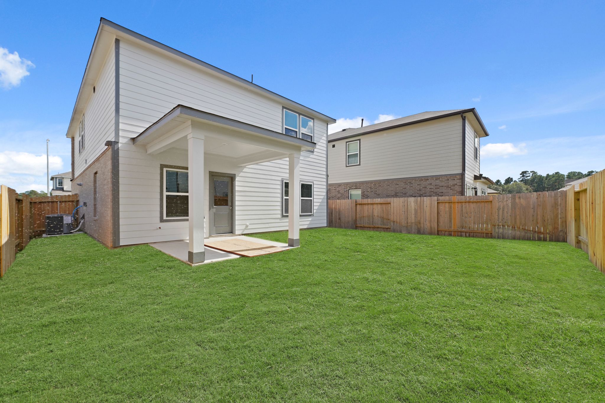 A house with a fence and grass.