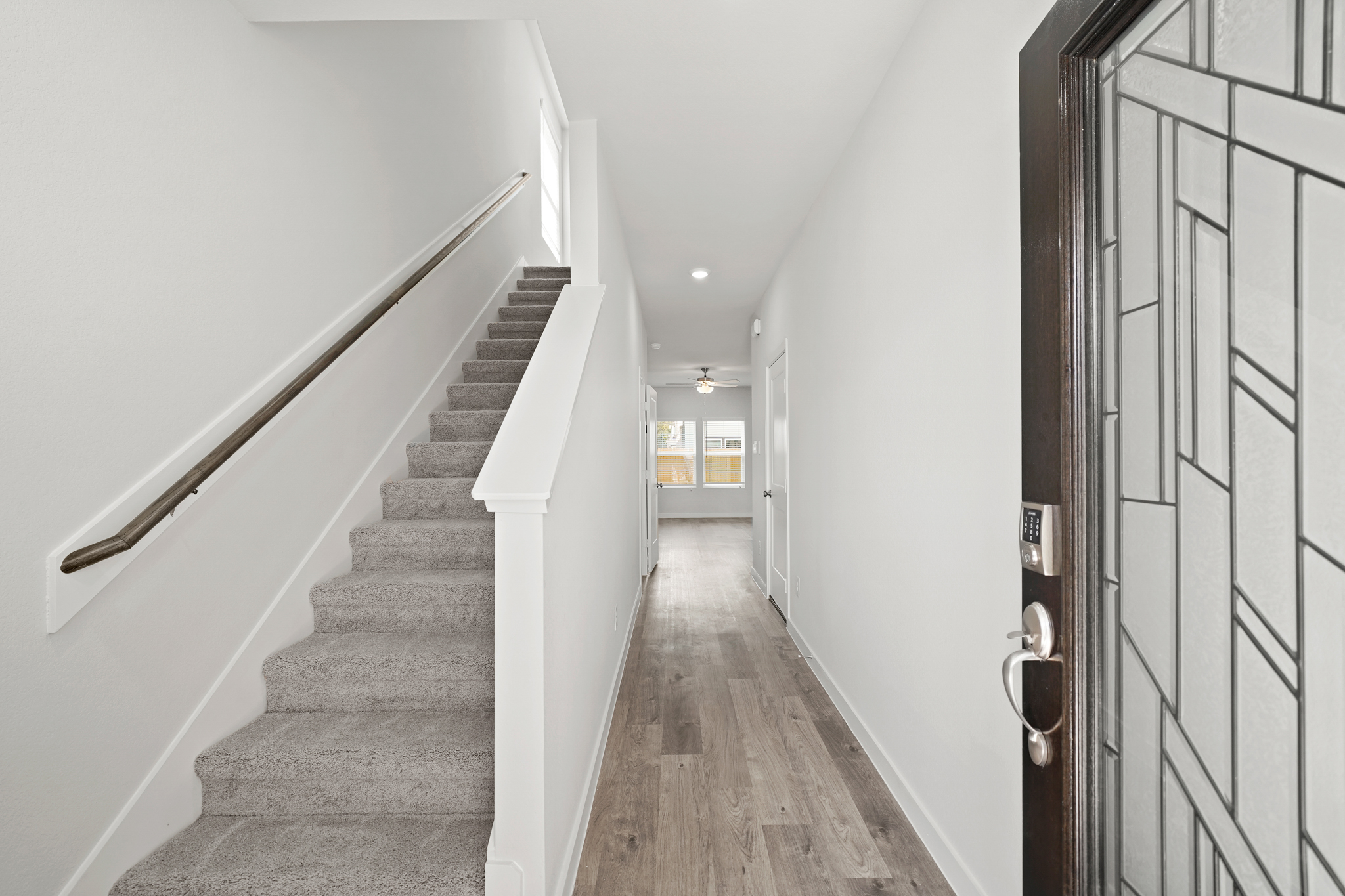 A long hallway with white walls.