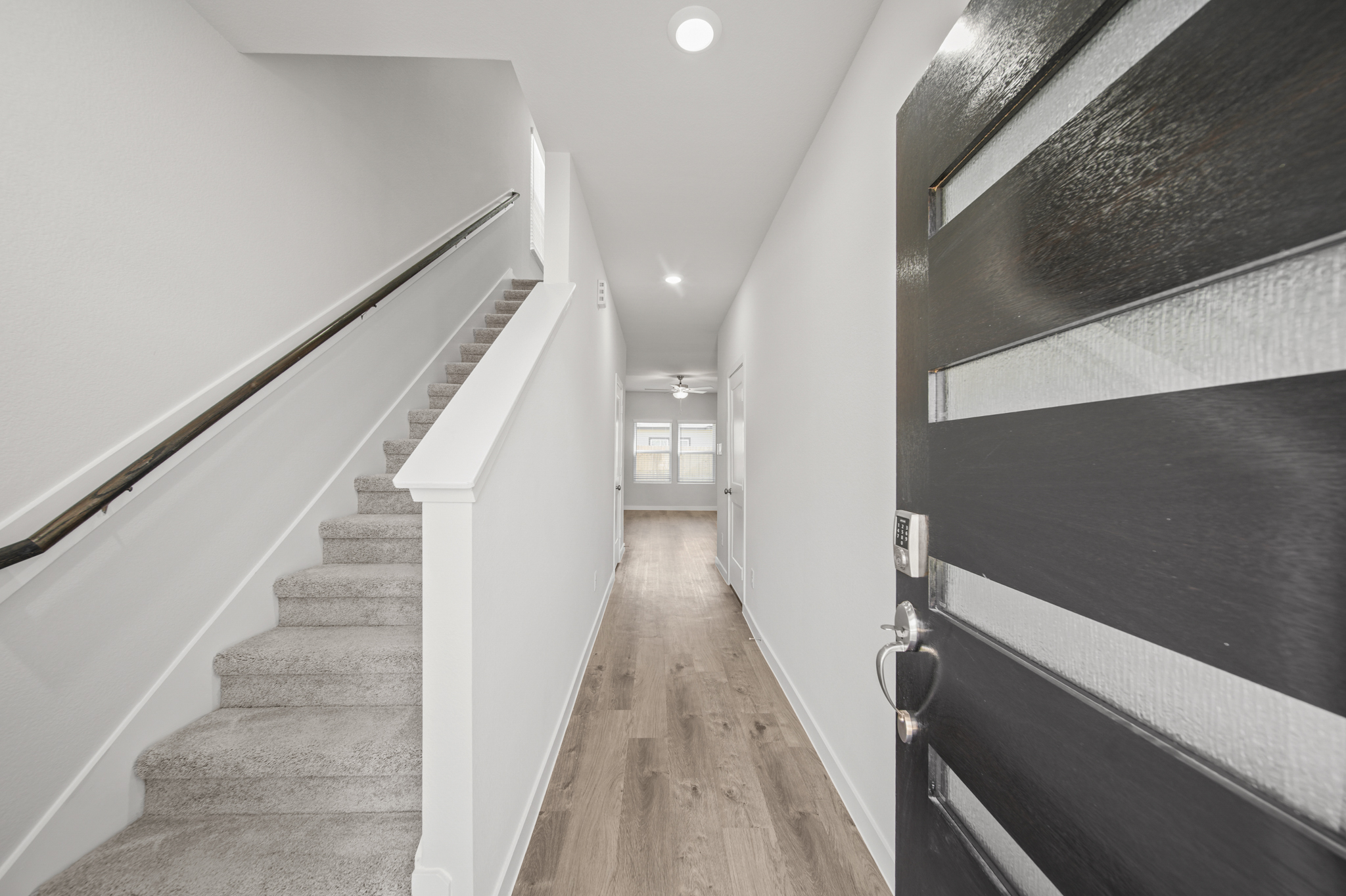 A long hallway with white walls.