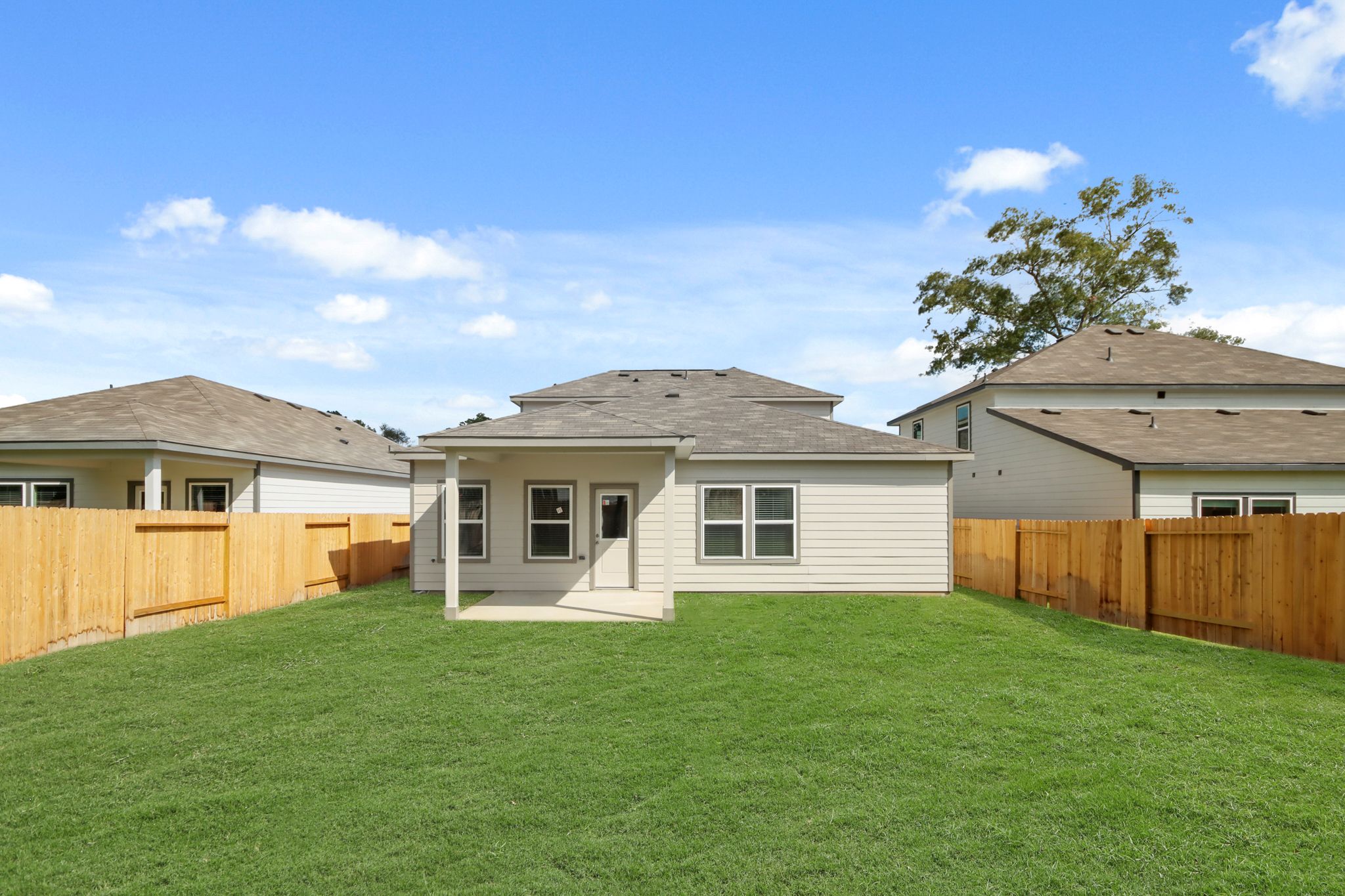A house with a fence and grass.
