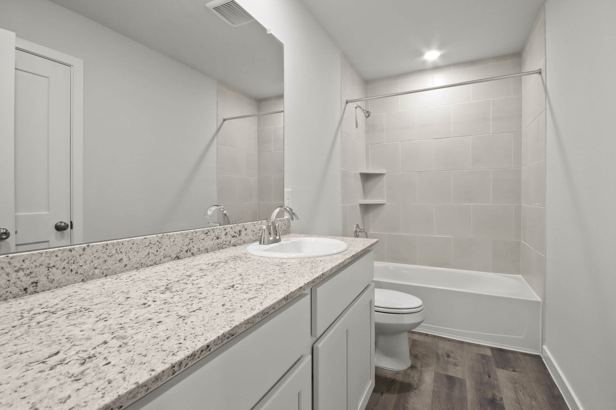 A bathroom with a marble countertop.