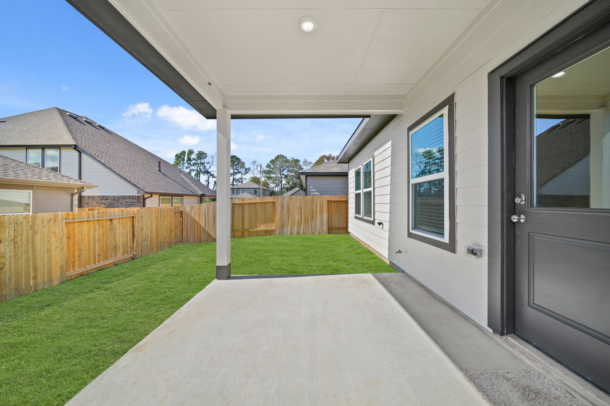 A house with a fence and grass.