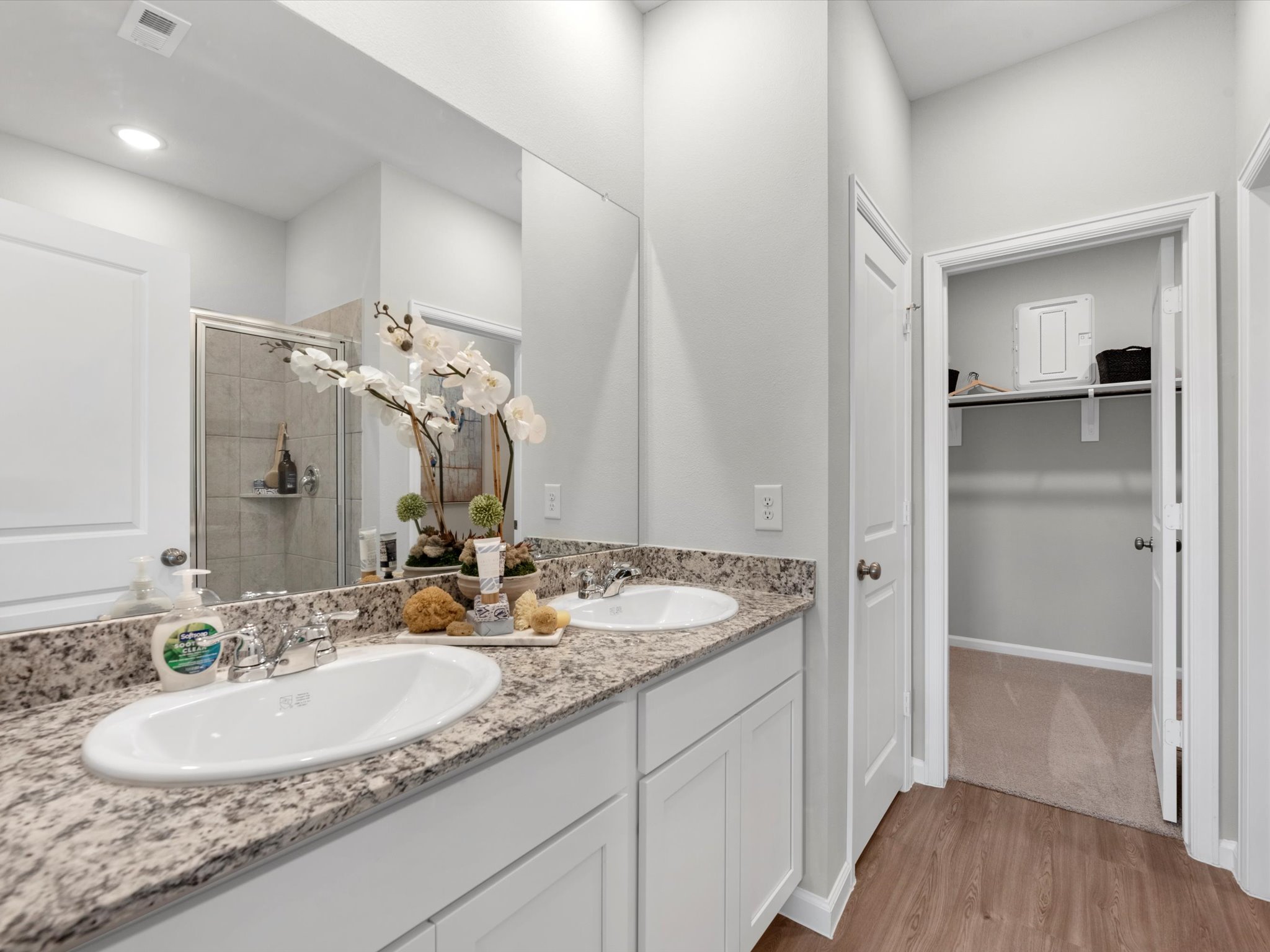 A bathroom with a large mirror.