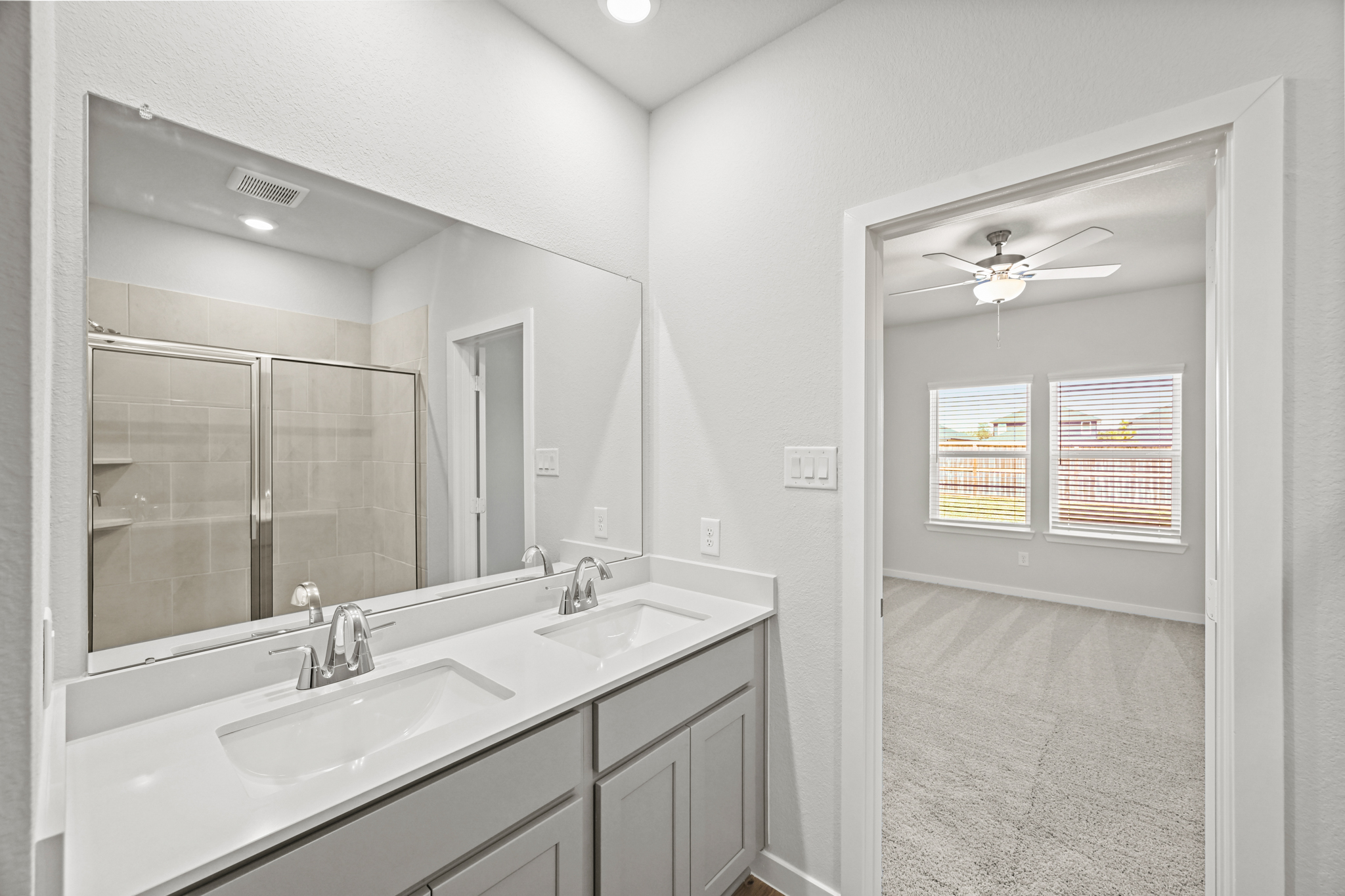 A bathroom with a large mirror.