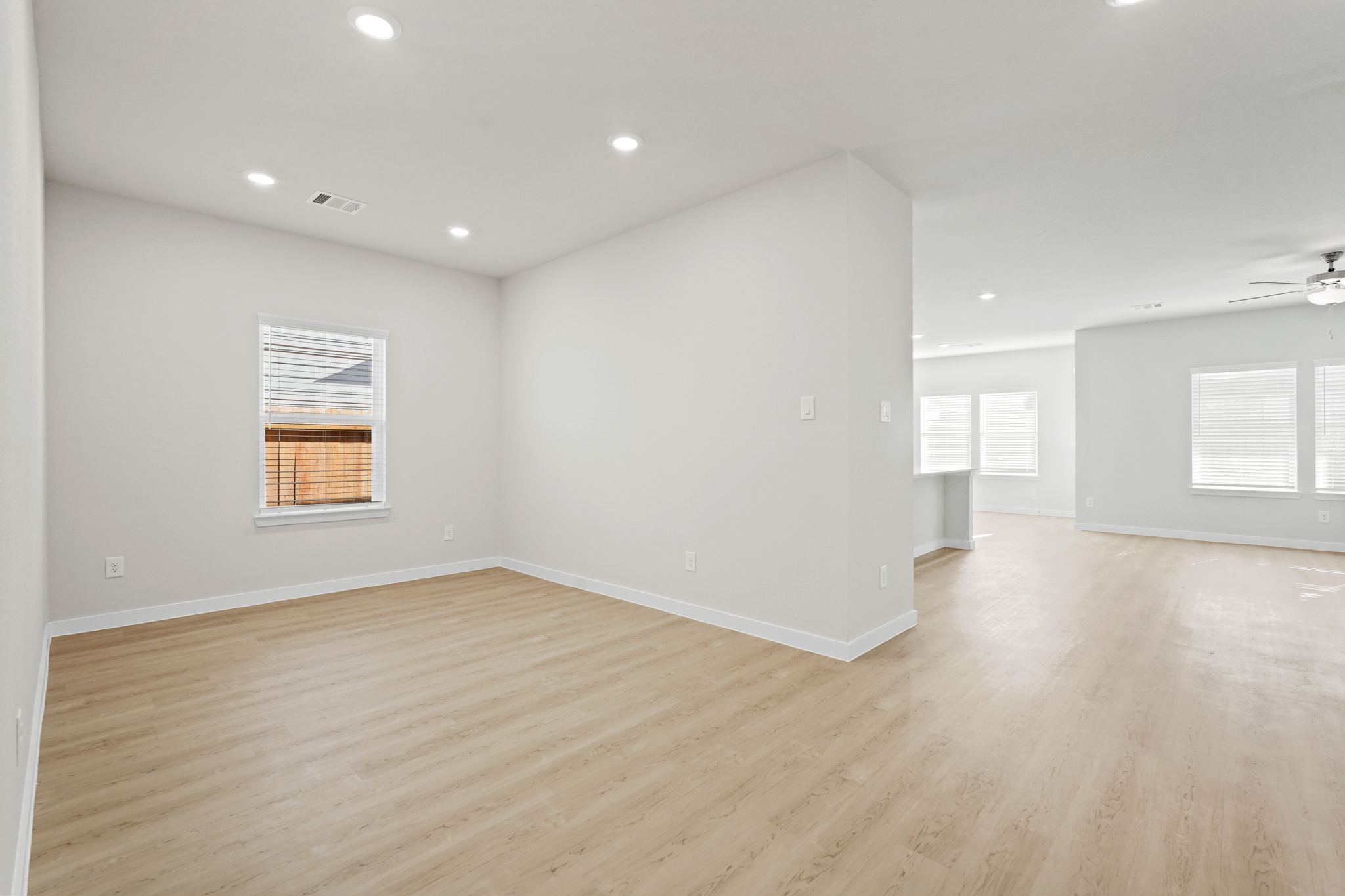 A room with a wood floor and white walls.