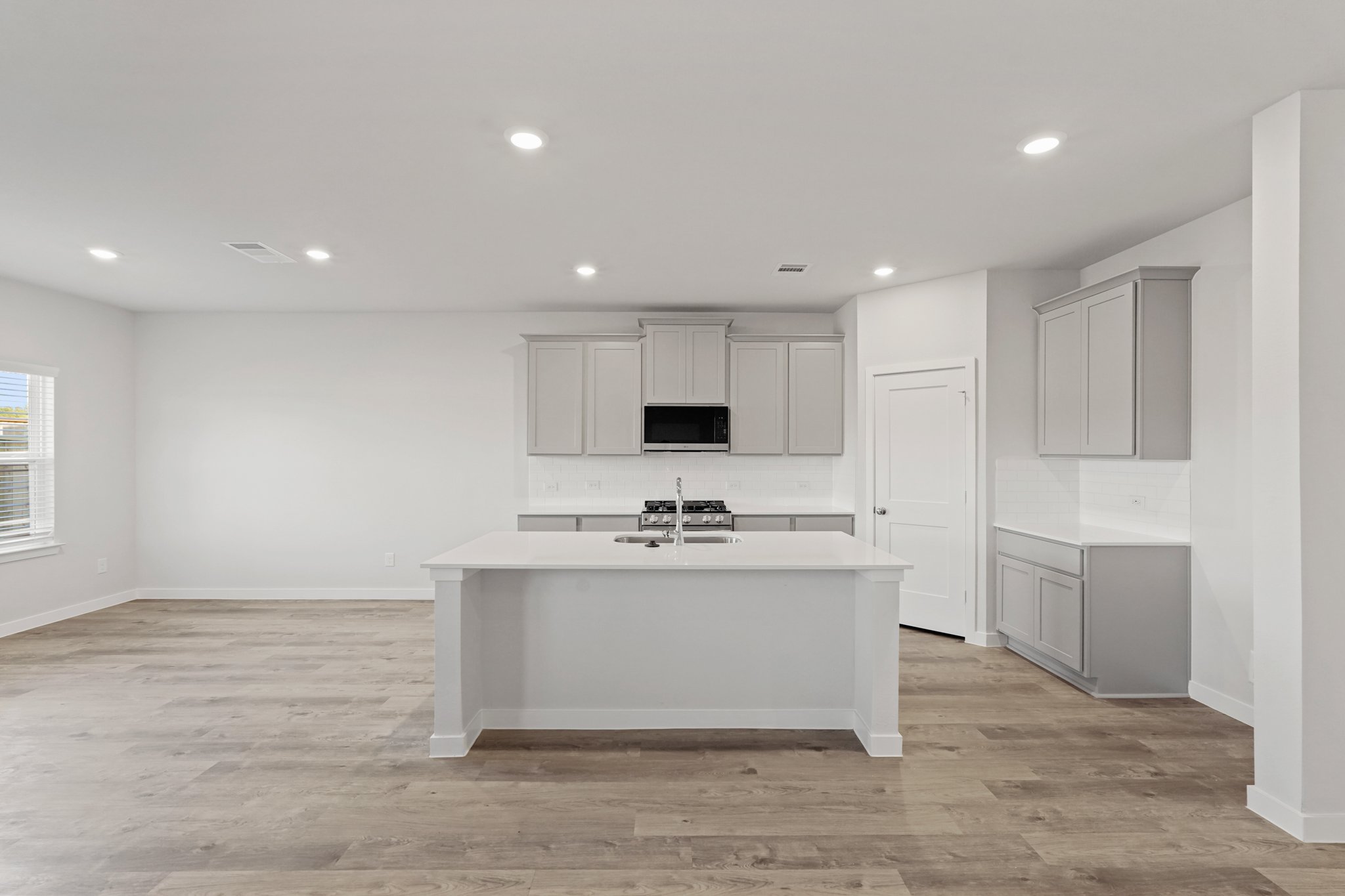 A kitchen with white cabinets.