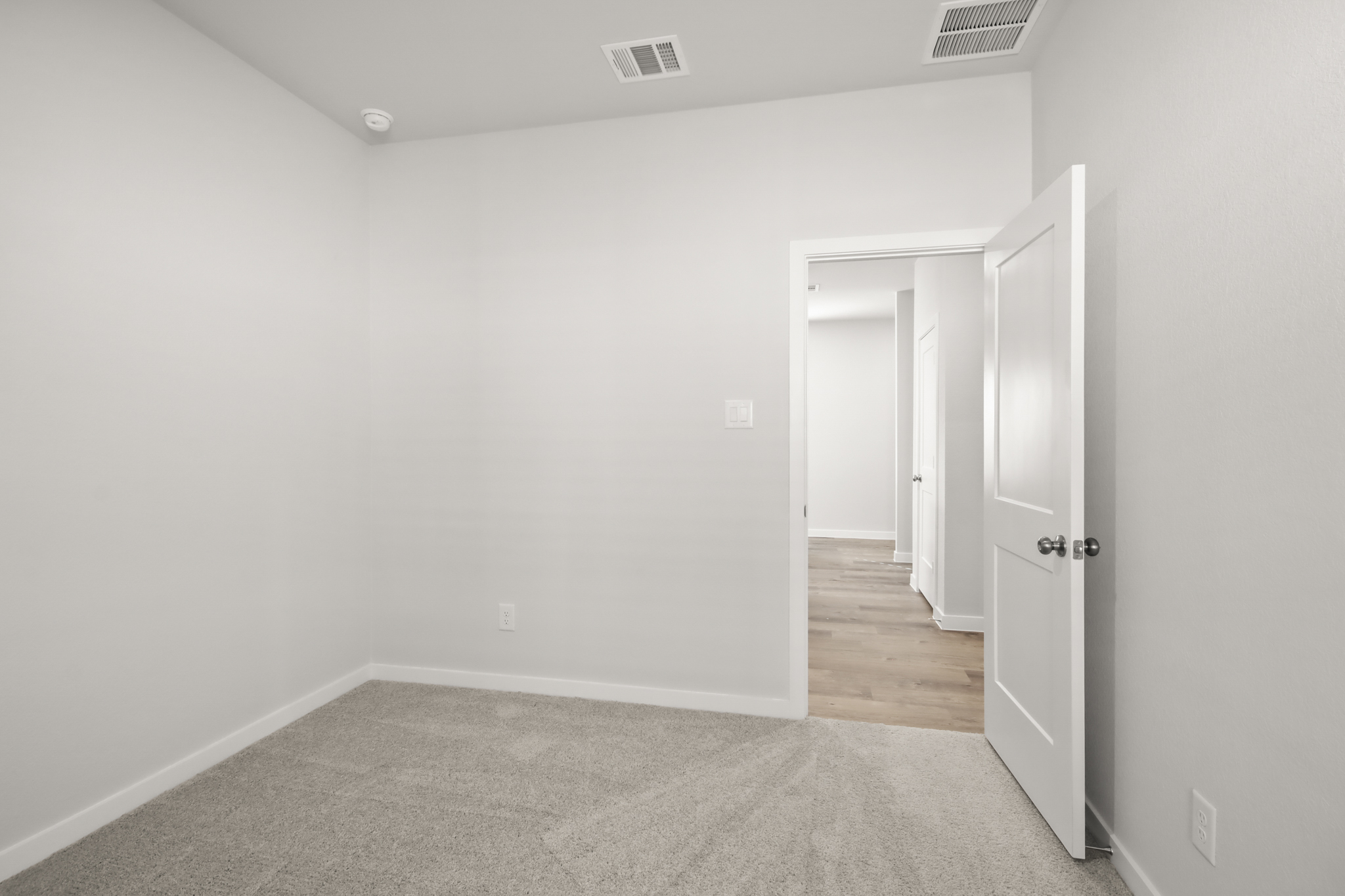 A hallway with white doors.