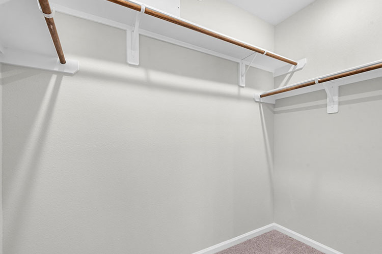 A white staircase with a red carpet.