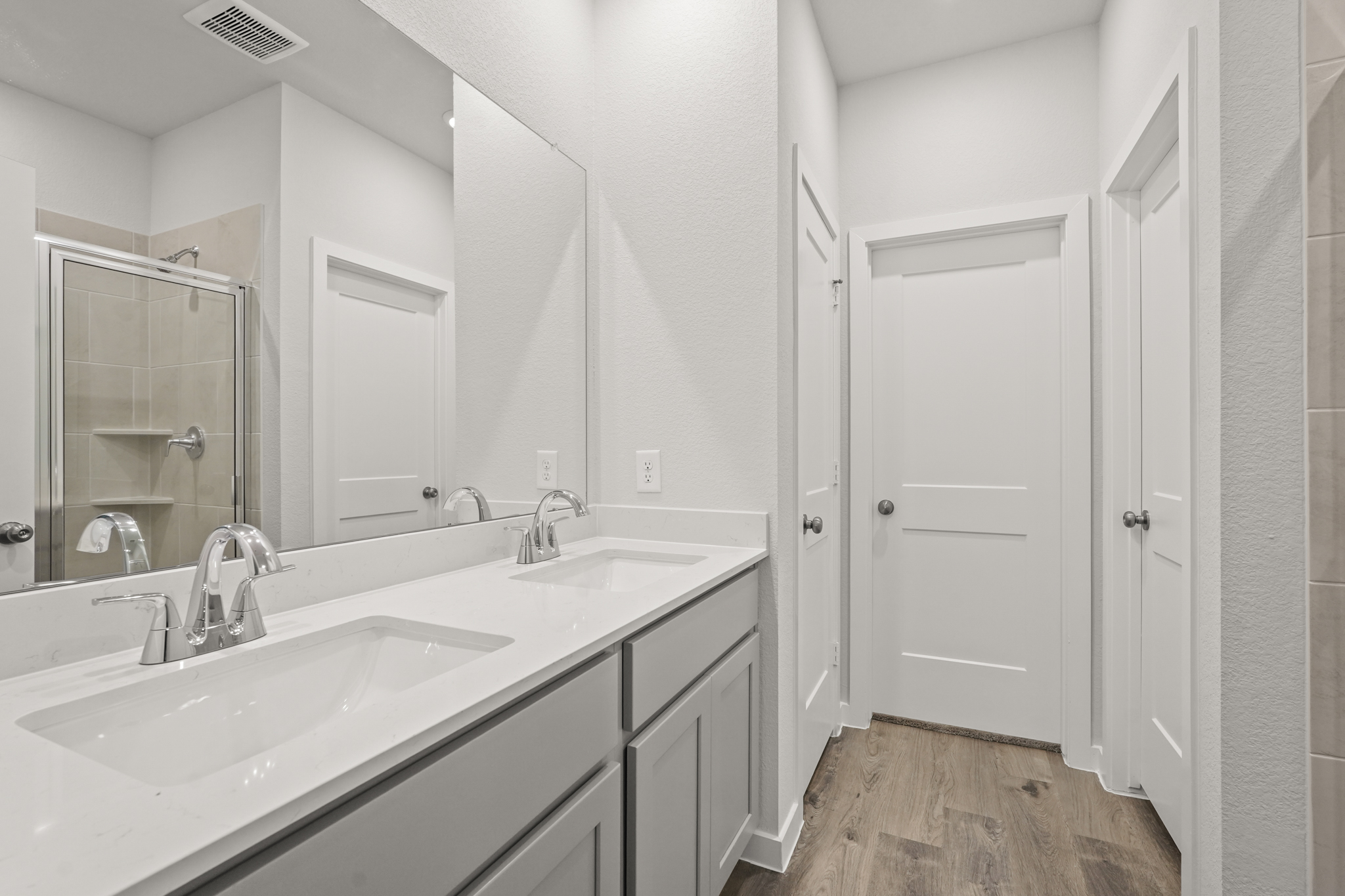 A bathroom with a large mirror.