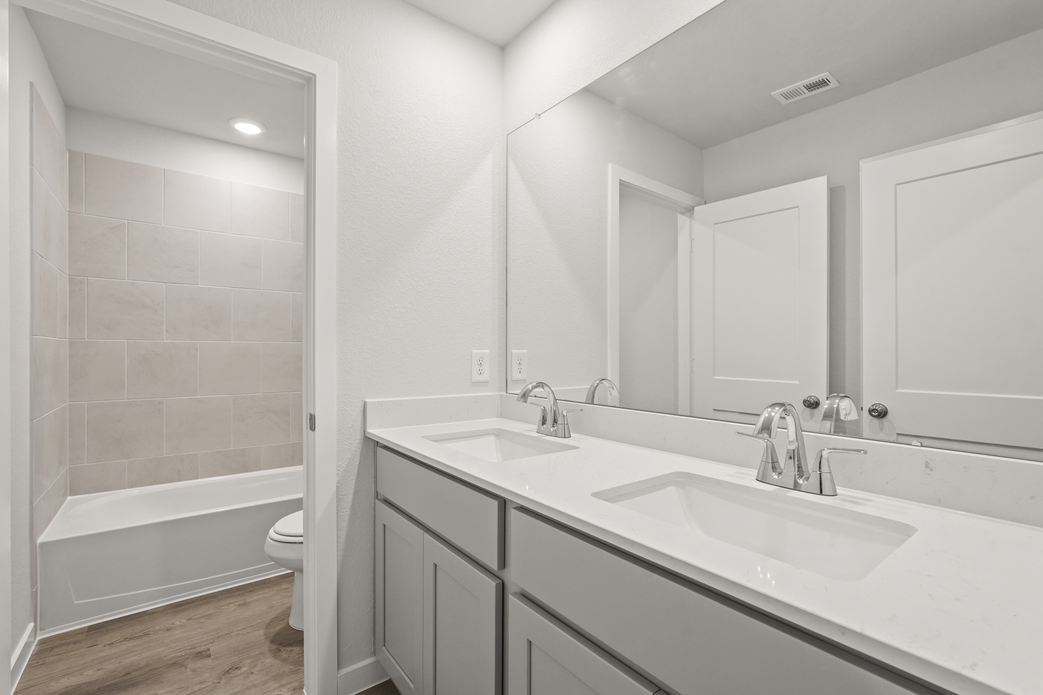 A bathroom with a tub sink and toilet.