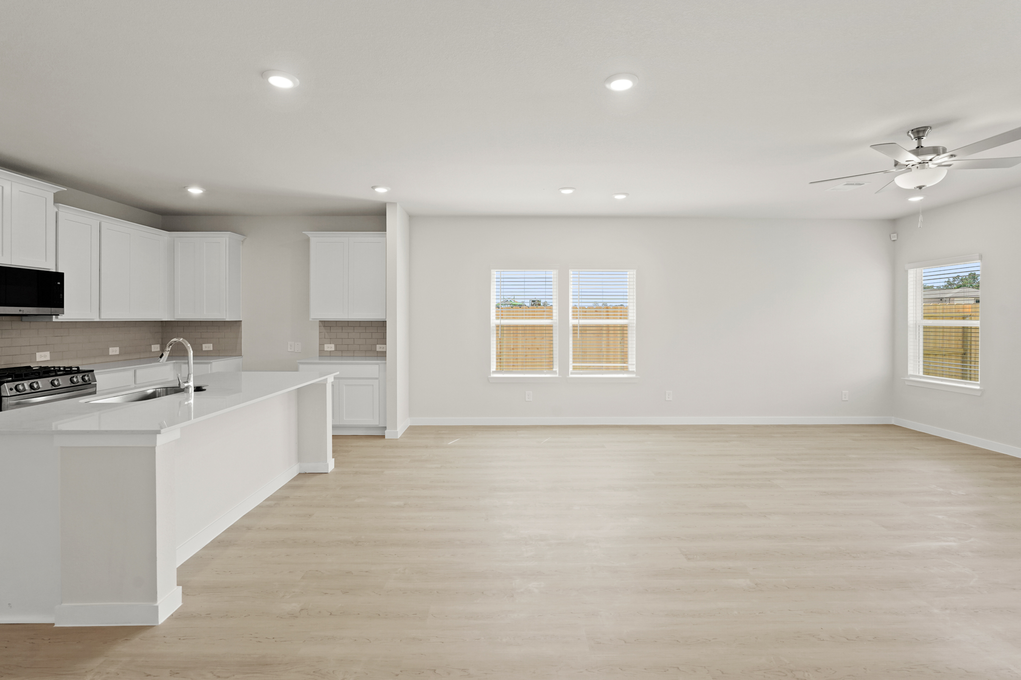 A large kitchen with white cabinets.
