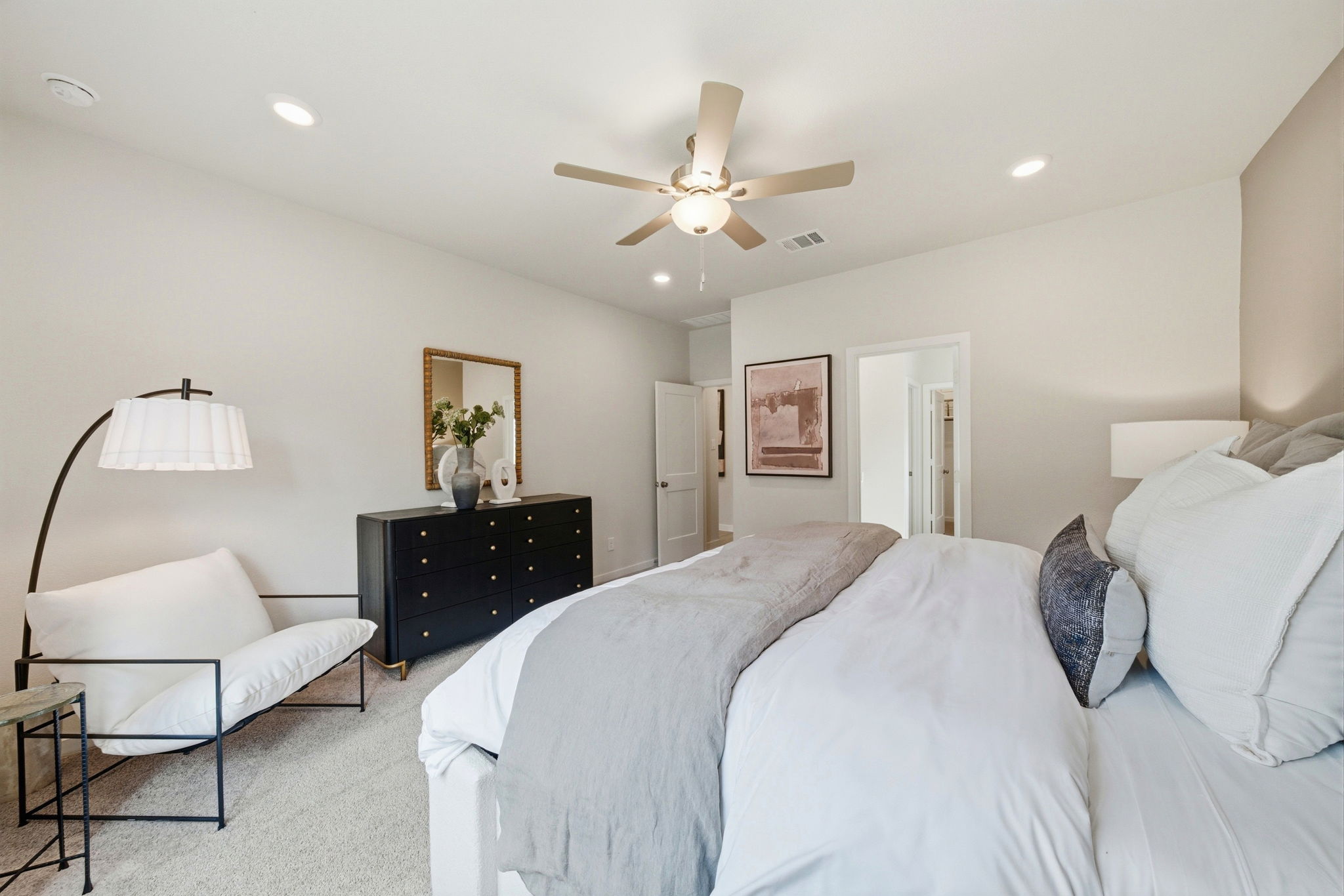 A bedroom with a bed and a fan.
