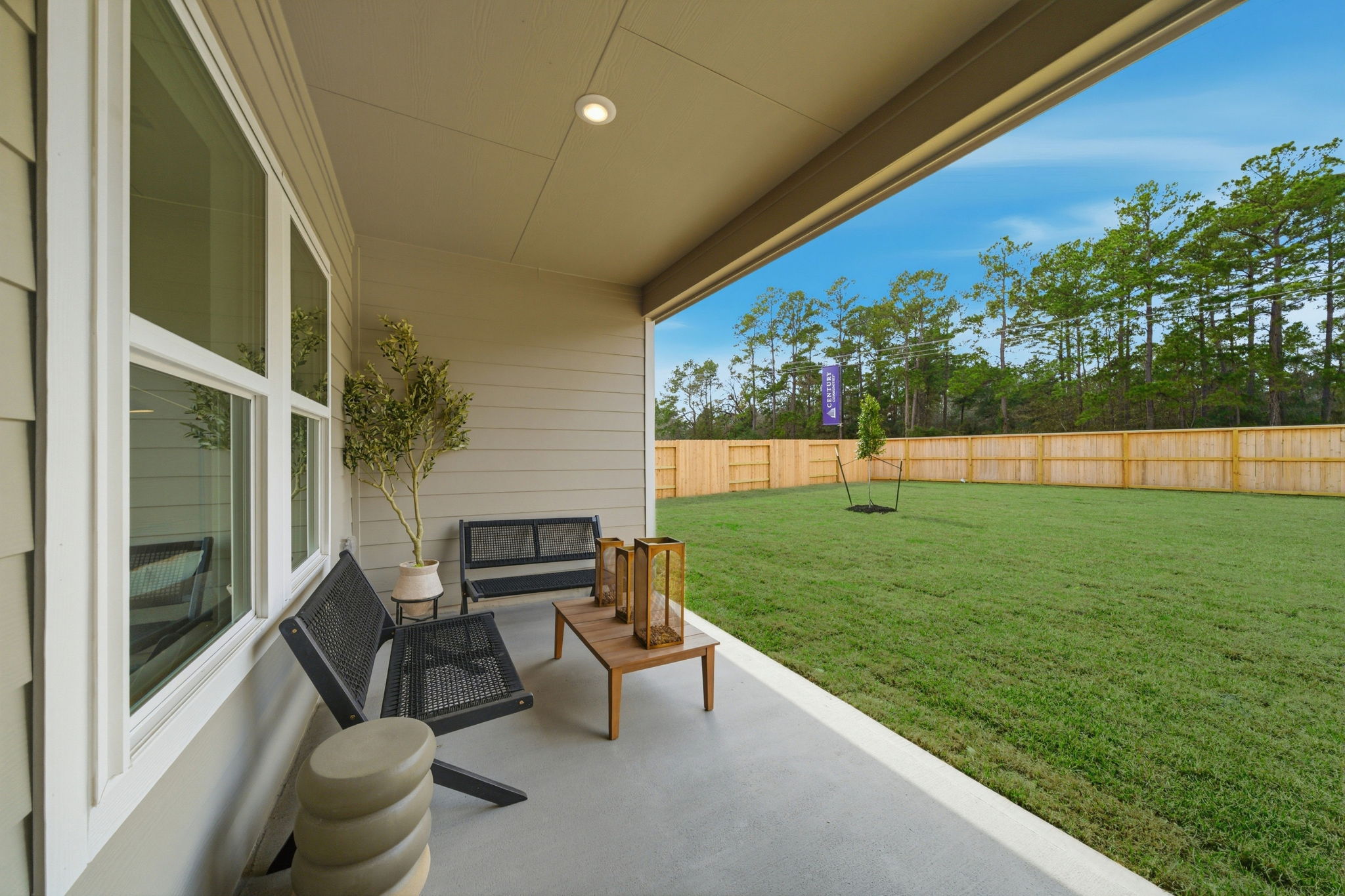 A backyard with a bench and a table and chairs.