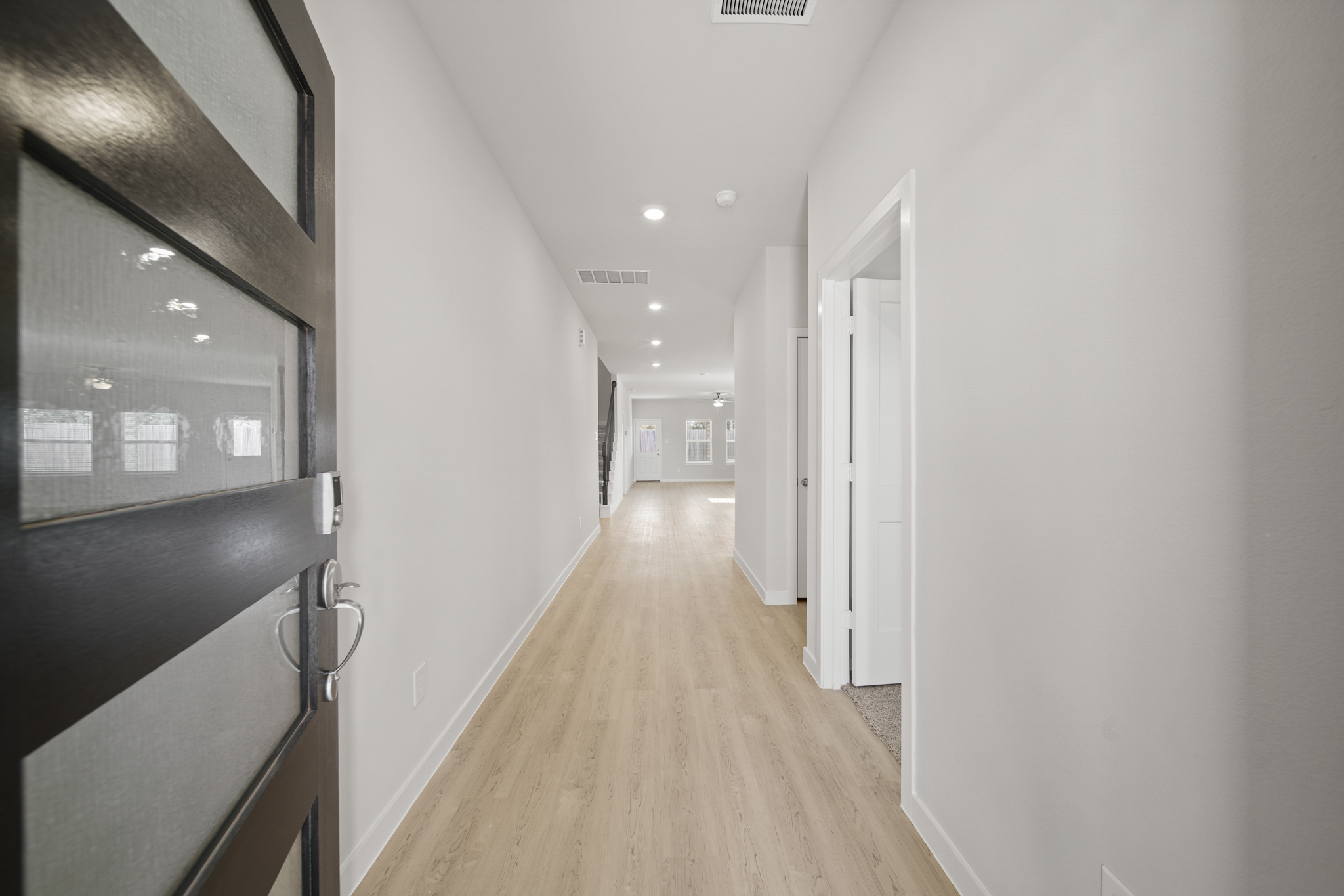 A long hallway with white walls.