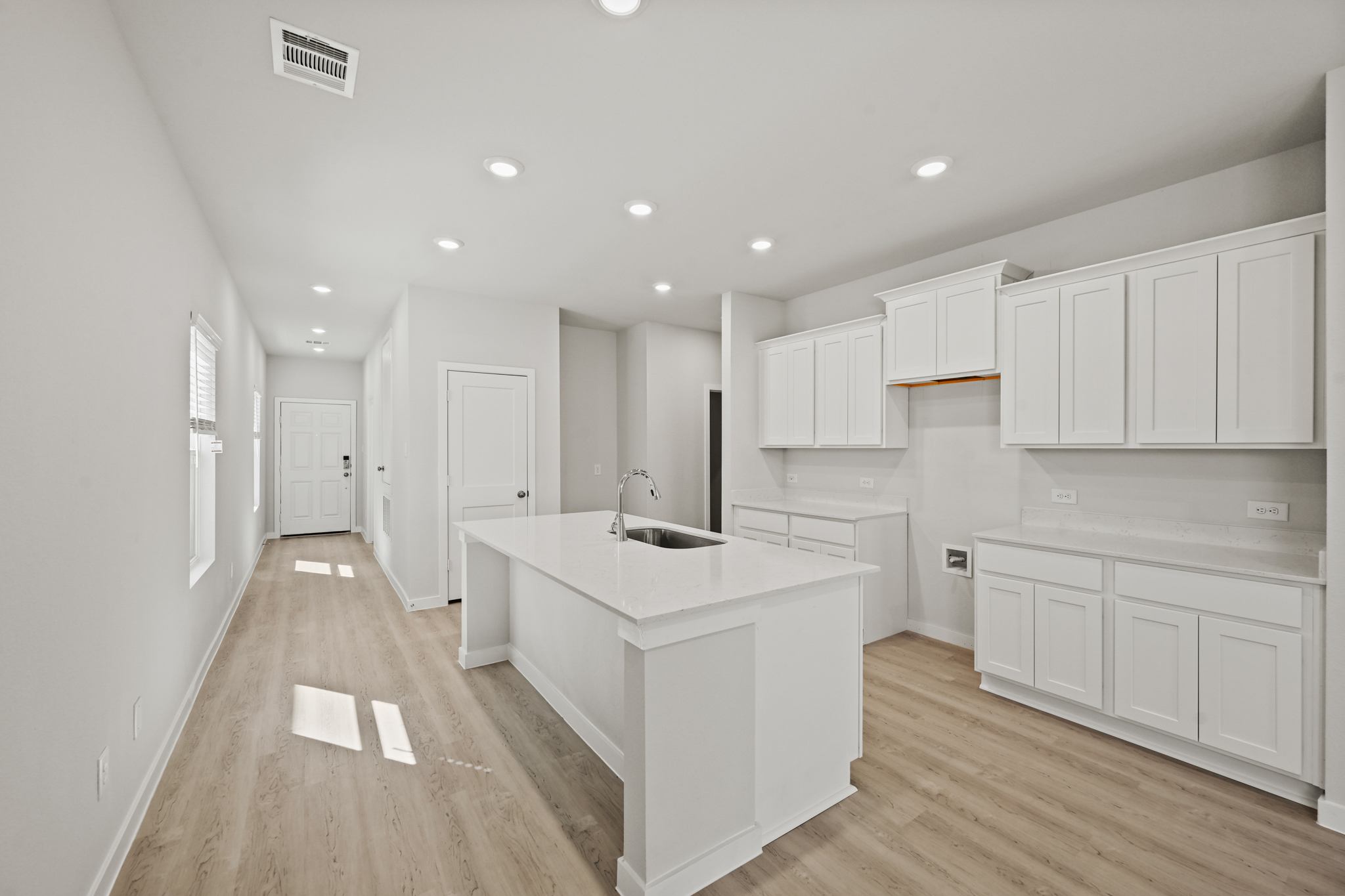 A kitchen with white cabinets.