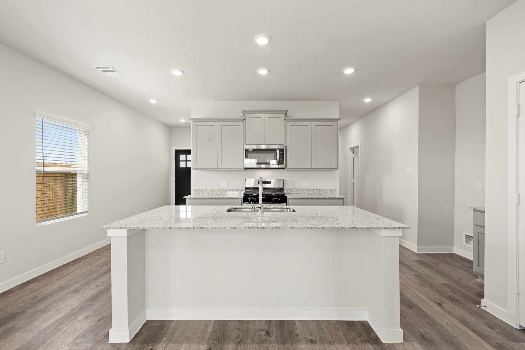 A kitchen with a marble counter top.